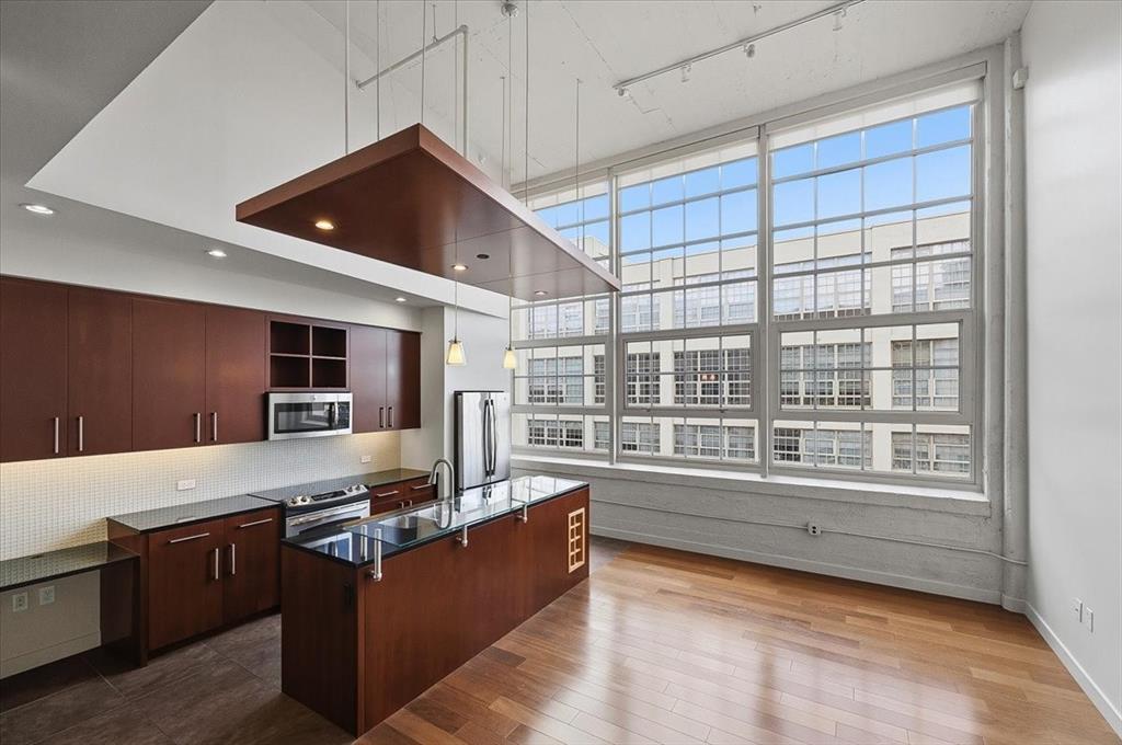 ADDITIONAL THIRD PARKING SPACE ! Rarely does an additional parking space become available at Montgomery Plaza. With an acceptable full-price offer, this residence includes a separately deeded oversized third parking space—a highly sought-after amenity that adds exceptional value and convenience. Located on the private residential floor, this sophisticated two-bedroom, two-bath condominium offers soaring 15-foot ceilings and an impressive 12-foot-high wall of windows spanning the width of the unit, filling the home with abundant natural light and showcasing views of the pool, cabanas, and Montgomery Plaza courtyard below. Designed for both comfortable living and effortless entertaining, the thoughtfully planned layout features a guest bath with direct hallway access—a desirable floor plan enhancement not found in many units. The spacious primary suite includes an ensuite bath with dual vanities, a soaking tub, separate walk-in shower, and generous walk-in closet. The residence also conveys two deeded parking spaces conveniently located in the East Tower Garage. Residents enjoy resort-style amenities including a rooftop pool and spa, six private cabanas, outdoor kitchens, grilling areas, fire pits, putting green, herb garden, state-of-the-art fitness center, owners' lounge, 14-seat media room, gated dog run, 24-hour concierge service, and secure access. Ideally situated in the heart of the vibrant West 7th district, residents enjoy premier shopping, dining, entertainment, museums, and downtown Fort Worth just moments from their doorstep. Experience the perfect blend of luxury, convenience, and lock-and-leave living.