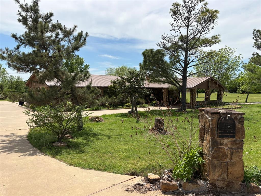 Set on an expansive 36 acres, this versatile property is ideal for a farm or horse ranch, offering the perfect blend of functionality and comfort. The home features attractive stone and veneer siding with a durable metal roof, combining rustic charm with long-lasting quality. Inside, you’ll find a cozy wood-burning fireplace, 2 bedrooms, and 2 baths, with a mix of carpet and tile flooring throughout.The kitchen is well-equipped with lots of cabinets and convenient down-draft venting for the stove, making it both practical and efficient. The guest bathroom offers a relaxing retreat with a jacuzzi bathtub and a separate shower in the primary bathroom. Ceiling fans throughout the home provide added comfort year-round. Step outside to enjoy the partially covered patio and large carport, perfect for entertaining or simply taking in the peaceful surroundings. The land is well-suited for livestock or recreation, featuring 3 ponds, a small horse stable, greenhouse, large workshop, and a storage outbuilding for large equipment. This property offers endless opportunities for country living at its finest.