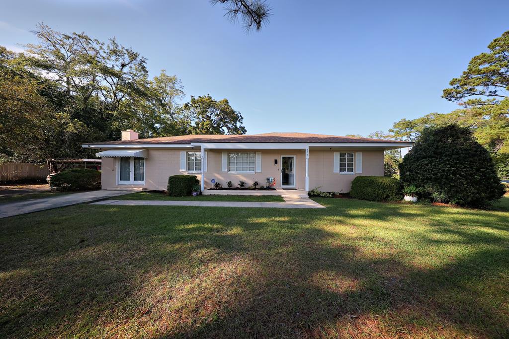 Stunning Mid-Century home on corner lot.  Located across from the Thomas University ballfields at Balfour Park, this beautiful 1950's ranch has been well-loved and meticulously maintained.  Only minutes from the historic Downtown Thomasville shopping district, where nationally and regionally known shops and restaurants attract visitors from across America and around the world.  With interiors featuring Bellawood floors and tongue and groove pine ceilings, there isn't another home so elegantly appointed in this range, New paint inside and out as well as a new roof, HVAC and attractive landscaping. Spacious kitchen with a gas range.  Gorgeous dining room, huge kitchen.  Bright and airy master bedroom with large windows adjoins a large bonus space currently used as a home office but could function as a nursery, gym or hobby room.  French doors open into the shaded backyard.  A giant family room, anchored by an impressive wood burning fireplace, is truly the heart of the home, and certain to be the site of many happy gatherings.  Outside, a 9x15 concrete storage building with attached carport will protect your vehicle and your toys.  You won't find a better value in a home.