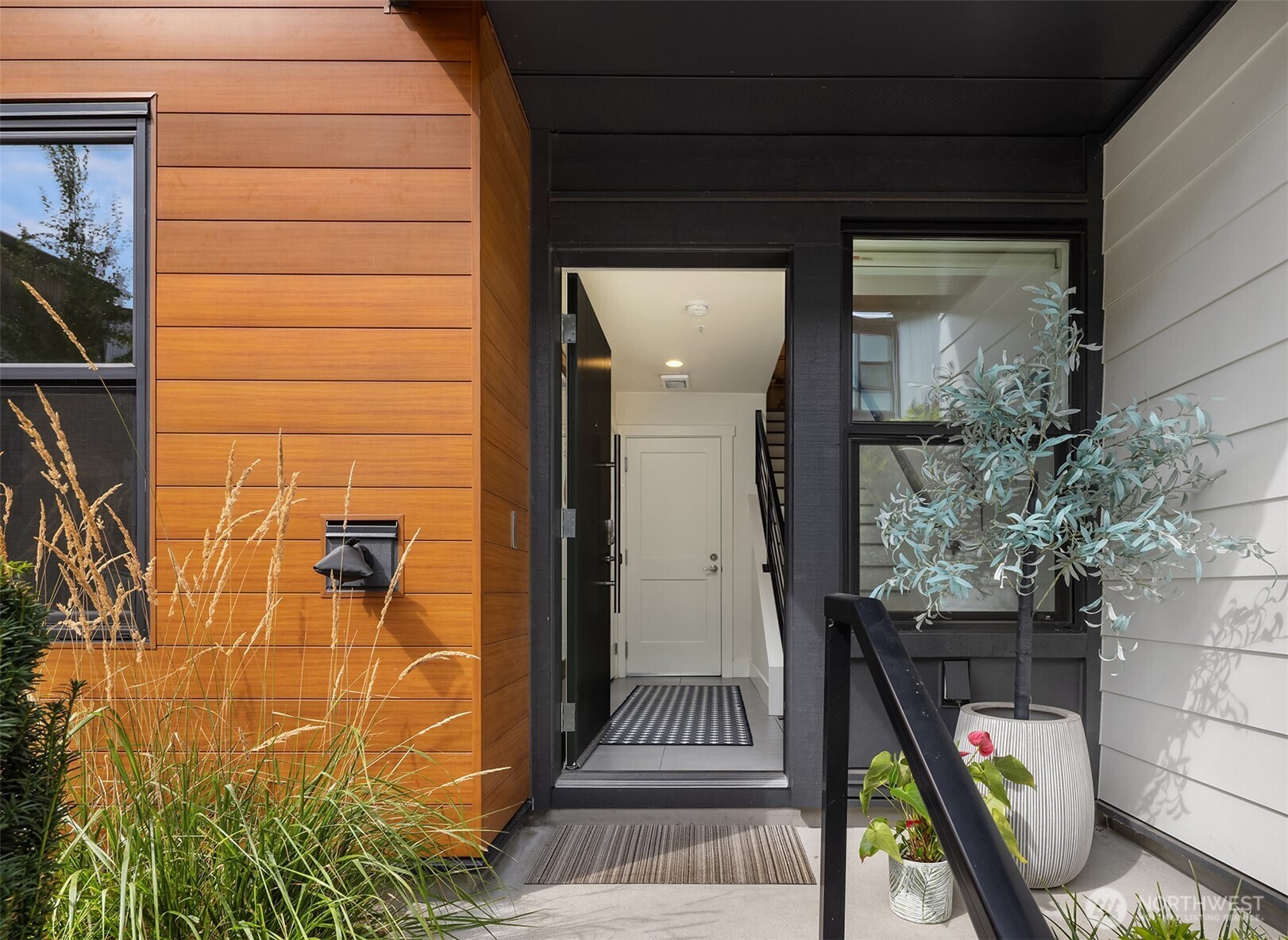 Spacious three-level townhome located in the highly sought-after Northshore School District, offering 1,537 square feet with 3 bedrooms and 3 bathrooms. South-facing, floor-to-ceiling windows fill the home with natural light, highlighting the open and flexible floor plan. The main level includes a convenient 3/4 bath, while the lower level offers a private guest bedroom or home office. The kitchen is thoughtfully designed with slab quartz countertops, an oversized island, stainless steel appliances, under-cabinet lighting, and a built-in beverage fridge. Hardwood floors, wrought-iron railings, split air conditioning units, and an EV-charger-equipped two-car garage enhance both comfort and functionality. Enjoy a private balcony and a prime Bothell location with easy access to downtown, shopping, dining, and transit.