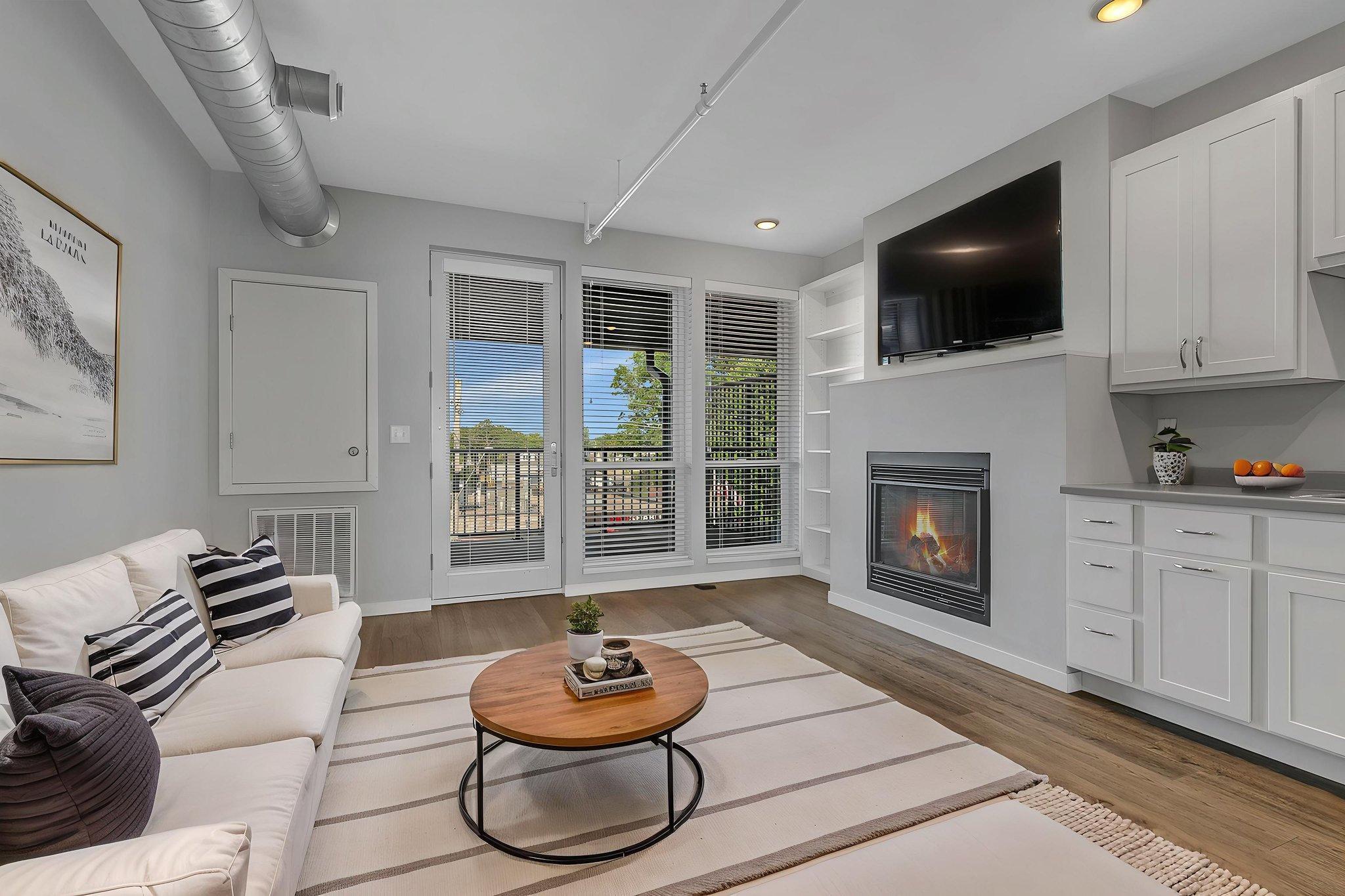 **Incentive - Go Under Contract For Purchase In 2026 And A Garage Stall Will Be Included!** Welcome to 24 North Lofts in sought-after downtown St. Joseph. This stylish luxury condo blends comfort and convenience, with parking lot access included and attached or detached garage spaces available for purchase. Enjoy a private balcony with wrought-iron-style railing, a patio door, and large west-facing windows overlooking treetops and downtown Saint Joseph rooflines. The open loft-style layout brings the kitchen, dining, and living areas together and features one bedroom, a den with a sliding glass loft door, a gas fireplace, built-ins, and a full bathroom. Just steps from top local shopping and dining, this inviting home is well suited as a primary residence or a rental when you're away. Nearby parks and trails add to the appeal, along with shared amenities including a fitness room, rooftop deck, and elevator, all partially powered by rooftop solar panels. Worry-free luxury condo living awaits—schedule your showing today!