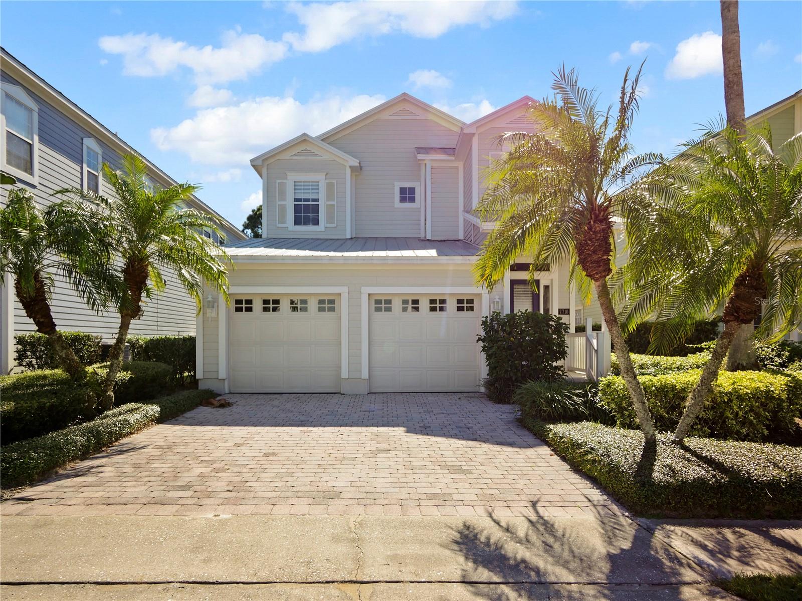 Price reduced for this beautiful 4/4 in Patriots Landing with no rear neighbors.  This home has a full length screened in covered patio that can be accessed by the beautiful French doors across the back wall, making this home feel it is one with nature.  Downstairs features a large dining area fit to entertain, with a large open family room and dining.  You have a view all the way from the kitchen.  The downstairs bedroom has a separate full bathroom while upstairs you have 3 additional bedrooms each with their en-suites.  The master bedroom is a luxurious suite with a splendid bathroom with a garden tub and separate shower.  The outside of the house was painted in August 2022, the owner also had the metal roof recertified around that time for insurance purposes.  The home boast 2 newer AC's and a new hot water heater too.  Inside has a fresh coat of paint done last year. Reunion is full of amenities.  There are several pools available, restaurants, playground, walking paths and fitness center. This is a great neighborhood to have your primary home or use it as short term rental investment property.  The owner will consider a contribution towards closing or for upgrades. My owner is motivated.