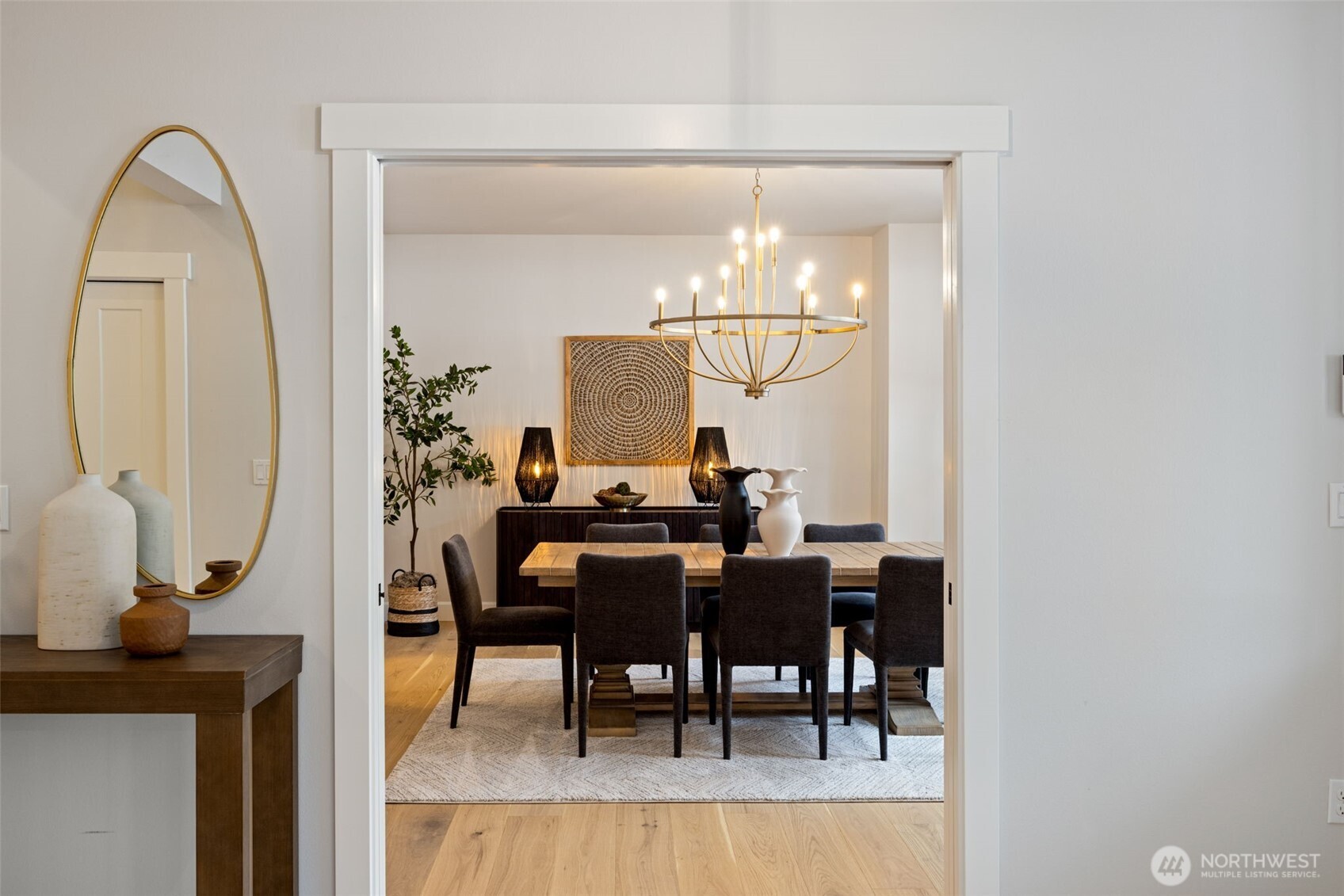 A beautiful, welcoming entry is framed by a dedicated dining room on one side and a versatile second living space on the other—perfect for creating an incredible home office, cozy den, or additional gathering area.