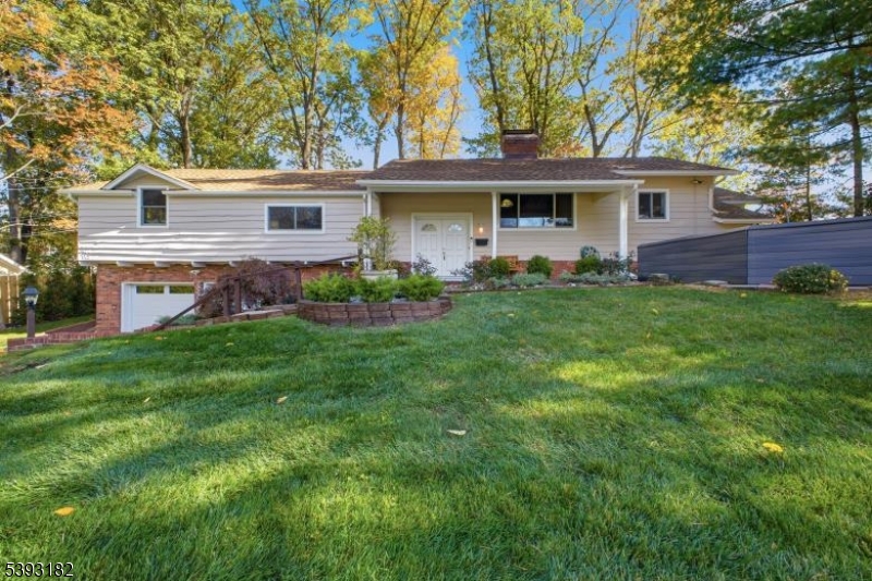 Nestled on a beautifully landscaped property, this spacious and well-loved home in the highly sought after Indian Forest section of Westfield is truly a gem. It's been meticulously maintained & thoughtfully updated throughout! Step inside to find gorgeous, refinished hardwood floors & brand new Anderson FiberX windows (2025) throughout. The remodeled kitchen (2025) is a dream - featuring top of the line appliances, quartz countertops, dimmable LED under-cabinet lighting, an undermount sink & sleek pull-out, self-closing drawers. The home's interior & exterior have been freshly painted in neutral colors & filled with natural light! You'll have plenty of space to entertain in the large living & formal dining rooms, featuring a cozy FP. Elegant French Doors from the dining room lead to an enclosed porch. The primary suite offers a relaxing retreat with a soaking Jacuzzi tub, shower, & walk-in closet complete with custom organizers, French doors lead to an enormous family room, another woodburning fireplace, a fourth bedroom with a private full bath, a kitchenette, and a large laundry room - ideal for guests. Additional highlights include newer HVAC (2022), gutter guards, two crystal chandeliers, three security doorbells, a Rain Bird irrigation system & a backyard gazebo - perfect for relaxing or entertaining.  You'll also love the new garage doors and thresholds with automatic openers (2025) as well as a lovely front garden area & patio. This home is larger than it looks!