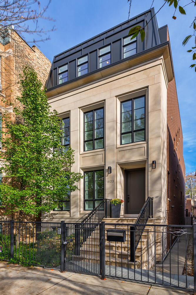 Meticulously maintained Platinum Homes resale with truly unbeatable Chicago skyline views! Located on the coveted east side (not on "L") of beautiful, lush Bissell Street! Completed in 2016, this elegantly designed limestone and brick home offers the ultimate in luxury living. Up to the minute finishes with ECO2 Lutron lighting, triple zone radiant heat, snowmelt on both the front and back patio all controlled through the convenience of your smart phone. Intricate millwork, poplar moldings, custom shutters and white oak plank flooring with herringbone inlay on the main level allow for a true air of sophistication. Step inside, where a gracious foyer welcomes you this outstanding open floorplan. Boasting a formal living and dining room with oversized west facing windows and a gorgeous, stone fireplace. Natural light pours through the main level with west, south, and north facing windows. Entertaining is truly easy in the sleek white kitchen boasting quartz countertops, a custom oversized statutory marble island, Wolf range and coffee maker, two Bosch dishwashers, SubZero fridge and freezer, fantastic pantry and storage space, plus a well-equipped butler's pantry with a u-line beverage center. East facing windows overlooking the incredible outdoor space is the focal view of the great room with custom built-ins surrounding a second marble fireplace. An extension of your home's living space, the adjacent back patio offers an outdoor kitchen with a woodburning fireplace and ample room to dine, relax, or play, plus access to the heated 2.5 car garage. The built-in mudroom area makes for easy in and out access with smart storage solutions. A powder room and ample storage space complete this level. Three ensuite bedrooms make up the second level, including the relaxing primary suite boasting dual walk-in closets, and a marble spa bath with dual vanities, an oversized soaking tub and steam shower. A fantastic laundry center with a sink and great storage space can also be found. Find the most magnificent views of the city just one floor up on your huge penthouse level roof deck! Opening up to an exceptional rec room with a wet bar and a huge guest bedroom and full bath. The lower has it all, featuring high ceilings, a generous family room with great built-ins, a third wet bar, two nicely sized bedrooms, a full white bath and secondary laundry. Perfect location in the heart of Lincoln Park, within walking distance to wonderful restaurants, parks, and Sheffield/Armitage shopping, plus in Oscar Mayer School District!