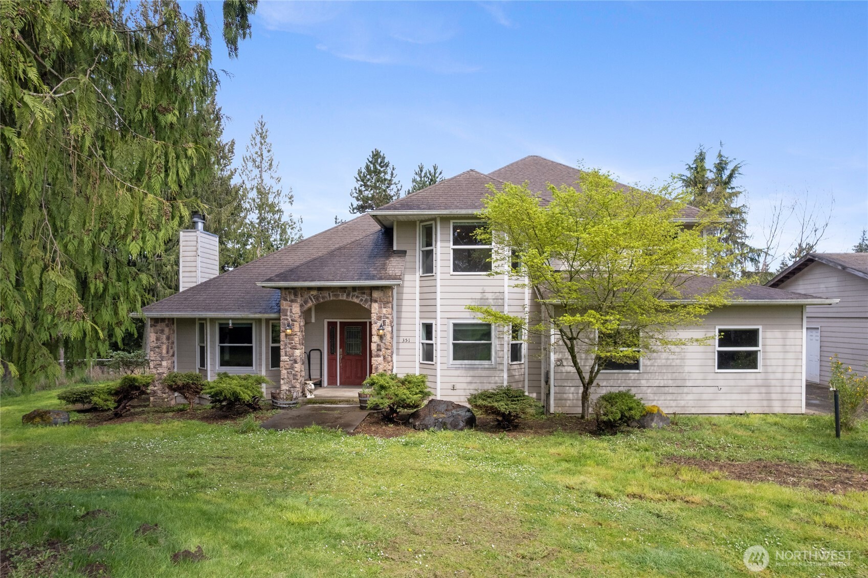 Private estate situated on approximately 18+ acres of predominantly level land with mature trees providing natural screening. Residence offers approximately 2,900+ square feet, featuring four bedrooms, den/office, two bonus rooms, and 2.5 bathrooms. Updated kitchen includes one-piece granite slab countertops, eating bar, and oak cabinetry, and opens to main living areas. Hardwood flooring.    Large patio provides outdoor living space. Dedicated craft/play room offers flexible use. A a 24x48 shop, 40x48 detached three-car garage, and 12x48 covered storage with concrete floor for RV/Boat/Tractor.    Property is located minutes from town with convenient access to I-5.