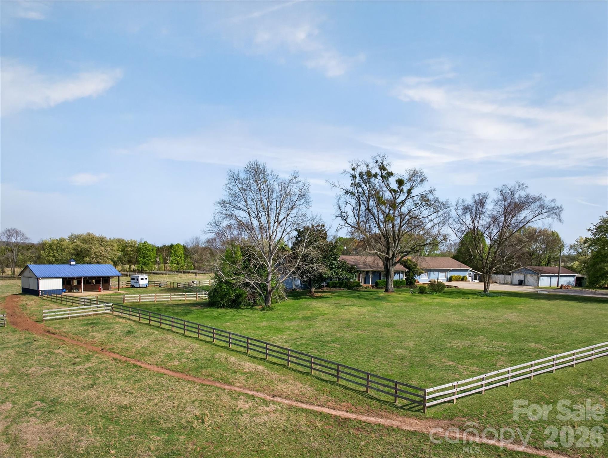 Have you been searching for that unicorn property that works for you, your horses, your dogs, extended family, and even your next big idea?Well… here it is.Set on approximately 8 acres in an incredibly convenient location near Tryon, Landrum, and Boiling Springs, this one-of-a-kind property delivers the kind of flexibility that is almost impossible to find. Whether you are dreaming of country living, an equestrian setup, space for multi-generational living, or room to grow a passion project, this property checks every box.The home has seen several updates and features 2 bedrooms and 2 baths on the main level, with recently refinished Alabama Pine hardwood floors, a striking custom fireplace, and a sunroom overlooking the horses and pasture. With all new windows and a mini split, the sunroom is ready for year-round enjoyment.The walk-out basement adds even more versatility with 1 bedroom, 1 bath, a full kitchen, and a large entertainment area—perfect for extended family, multi-generational living, guest quarters, or a caretaker’s residence. For added peace of mind, a radon mitigation system was installed in 2023.Horse lovers will appreciate the thoughtful farm setup, including a 3-stall shed row Morton barn with overhang, tack room, hay storage, thriving pastures, recently replaced 3-board fencing, and cross-fenced pastures for easy rotational grazing.And then there is the bonus space that truly sets this property apart: an attached climate-controlled building with over 3,100 square feet, previously operated as a successful pet boarding business. The possibilities here are endless—hobby space, workshop, storage, home-based business, or future venture. Out back, you’ll find 30 climate-controlled kennels with exterior access, plus multiple fenced runs for dogs.This is more than a home. It is a rare chance to own a modern, flexible farm property with room for your lifestyle, your animals, your family, and your future.THIS PROPERTY IS BY APPOINTMENT ONLY! Please do not drive into the driveway without an appointment to keep dogs in the yard safe!