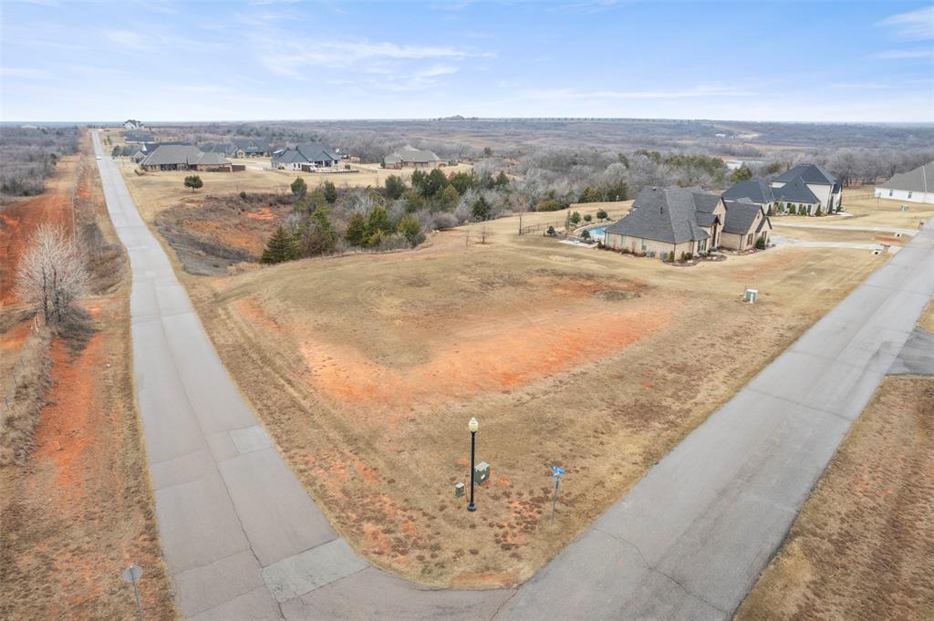 Rare opportunity to build in highly sought-after Manor Lake Hills! This premier gated community offers peaceful luxury just 15 minutes from Downtown Norman. One of the final homesites available, this prime 2+ acre corner lot sits at the top of the hill, offering privacy, sweeping views, and breathtaking Oklahoma sunsets.

The wide frontage allows ideal placement for a side or rear-entry garage, while the depth of the lot provides room for a grand front facade and circular drive. With generous space for your custom residence, pool, outdoor living, shop, or extended driveway layout, the property offers exceptional flexibility to create an estate-style home. Mature natural surroundings enhance the tranquil feel.

Neighborhood amenities include scenic walking trails, a stocked fishing pond, community pool, and clubhouse. Near shopping, dining, entertainment, and highway access, this location offers the perfect blend of space, beauty, and convenience. Don’t miss this chance to secure one of Norman’s most desirable remaining lots—ready for your vision.