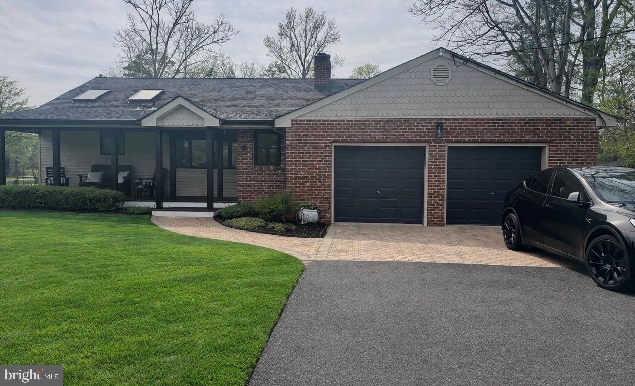 Welcome Home to This Exceptional Lakefront Rancher!Step inside this stunning 5-bedroom, 4-bathroom lakefront rancher, thoughtfully and completely remodeled in 2022 to offer the perfect blend of luxury living and private retreat space—designed for both everyday comfort and unforgettable entertaining.As you enter the main level, you’re immediately drawn into the retro-modern living and parlor space, where expansive sightlines lead straight through to the deck and sparkling lake views. Anchored by a custom live-edge wood mantel, this inviting space sets the tone for the home—warm, stylish, and effortlessly connected to the outdoors. Step out onto the upper-level deck to take in peaceful water views and the natural beauty that surrounds the property.Just beyond the living space, the heart of the home awaits: a show-stopping chef’s kitchen professionally designed by a renowned chef to maximize both function and style. Culinary highlights include an 8-burner Jenn-Air range with double ovens, an additional third wall oven, commercial-grade hood ventilation, pot-filler  and a brand-new smart refrigerator with touchscreen access—perfect for recipes, streaming, or staying connected while you cook. Vaulted ceilings with electric skylights flood the kitchen with natural light, enhanced by Andersen windows featuring professional UV tinting for improved energy efficiency. Panoramic lake views make dining at the table or relaxing on the kitchen sofa an everyday experience.Continuing down the hallway into the west wing of the main level, you’ll find a thoughtfully designed bedroom layout featuring  a private primary suite with en-suite bath and wraparound windows offering breathtaking 180-degree lake views. Two additional bedrooms and a full bath complete this wing, ideal for family or guests. This level also provides convenient access to the laundry facilities and direct interior entry to the heated two-car garage, which is equipped with EV charging, making the home both comfortable and future-ready.Make your way downstairs to the walkout lower level, which offers exceptional flexibility and can easily function as private guest quarters or an in-law suite. This level features a spacious family room with coffee/wet bar, a full guest bedroom, and a full bathroom—perfect for hosting or extended stays. Continue into the lower west wing to discover a secluded primary-style retreat complete with its own exterior entrance, private office, and spa-inspired bathroom featuring heated floors, a soaking tub, open tiled shower, and custom his-and-hers walk-in closets with private laundry.Step outside to your resort-style backyard, where lake living truly shines. Enjoy a covered patio, screened porch, outdoor Viking chef’s kitchen, and a newer dock overlooking the lake—ideal for fishing, paddle boating, or simply watching the birds and turtles glide by. The property features a lake-water–supplied sprinkler system to keep the landscaping lush and efficient, along with an electric dog fence that extends into the lake, offering a safe and secure environment for pets to roam and even enjoy dog-friendly swimming.Additional highlights include a custom outdoor storage shed, a charming front porch—perfect for sipping your morning coffee—and thoughtful systems that enhance ease of living year-round.This one-of-a-kind lakefront home offers space, flow, modern convenience, and an exceptional lifestyle—inside and out. This home won't last. Schedule your viewing now - Open's April 15th!