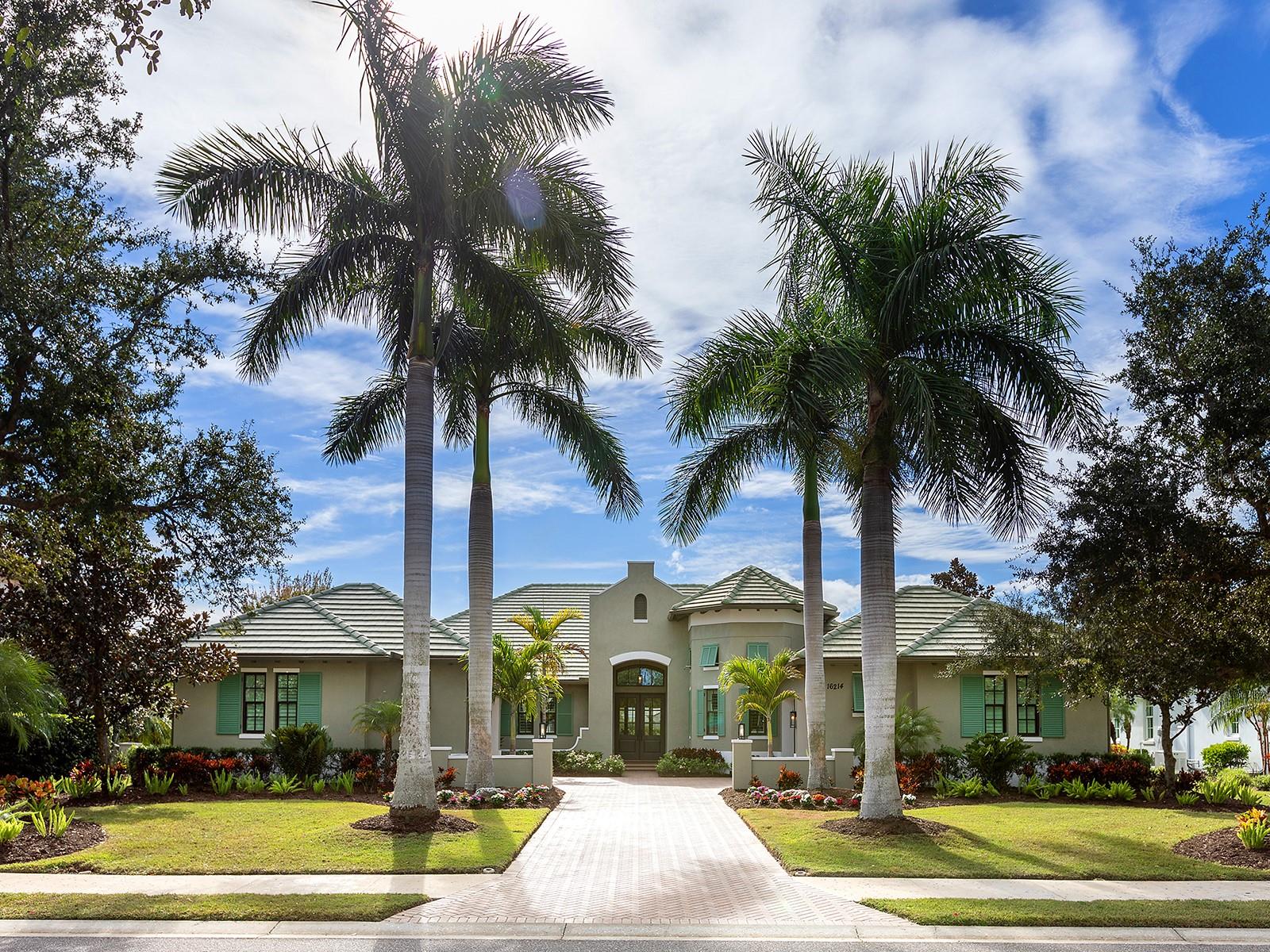 Under contract-accepting backup offers. Amazing lake views in The Lake Club!  Located in the original phase of The Lake Club, this lakeside custom Bermuda residence by Arthur Rutenberg is your cozy and luxurious private oasis.  Spanning almost 3,500 square feet, this functional floor plan offers a modern open flow plus a massive study with high ceilings, extended bonus room, and 4-car attached garage.  From the moment you arrive home, you will appreciate how this residence expertly balances timeless elegance with unique elements you won’t find at other properties.  The mediterranean exterior shines between towering palm trees and elegant wing walls from the long driveway to your split 4-car garage bays, both with their own private attached entrances to the interior.  Through double wood front doors, the foyer offers a stately entrance with custom tile inlay design in the wood floors, designer wallpaper feature wall, and instant views of the lake over the southwestern rear exposure.  The central great room is a bright place to gather with tall tray ceiling, large impact sliding glass doors, and custom feature wall.  The chef’s kitchen delights with a completely custom island taking center stage featuring plentiful storage, granite counters, and a custom wood bar for guests to watch the chef in action.  Enjoy wood cabinetry with 2025 fresh super white paint, cleverly hidden walk-in pantry with shelving, and a dream stainless steel appliance suite with Wolf gas cooktop and griddle, built-in wall oven and microwave, dishwasher, refrigerator, and wine fridge.  The adjacent dining room allows for seamless indoor and outdoor entertaining with disappearing corner impact sliding glass doors to the lanai.  The paver lanai surrounded by a classic colonnade screen enclosure is perfectly situated lakeside for the most incredible sunset views every evening.  Plus, covered entertaining areas with wood ceilings, retractable shade awning and additional rolldown shade screen, custom outdoor kitchen with grill, built-in firepit, and heated saltwater pool with large sunshelf.  Inside are the perfect places to work and play, with an oversized den that has space for two separate work areas and designer chandeliers, and a spacious bonus room with custom wet bar and impact sliding glass doors to the lanai.   The primary suite is a comforting place for respite with large windows overlooking the lake, and dual walk-in closets.  Have a spa-day everyday in the en-suite bathroom with dual vanities, makeup vanity, large soaking tub, and walk-in shower with multiple shower heads.  Two guest bedrooms, both with walk-in closets, are ready for your guests, plus two full bathrooms, one of which is a great pool bathroom.  There are no storage woes in this house with extra linen closets, large storage closet by the laundry, and an additional 13x13 storage space in the left garage that is perfect for a workbench or golf cart parking.  Rounding out this impressive estate is a functional laundry room, and mudroom entry off the left garage.  Recent upgrades in November and December 2025 include: fresh interior paint in the main living areas and bonus room, new tankless water heater, and new whole house water softener and filtration system.  The Lake Club is an exclusive premier, gated community with a Grande Clubhouse, restaurant, pool, tennis, pickleball and more.