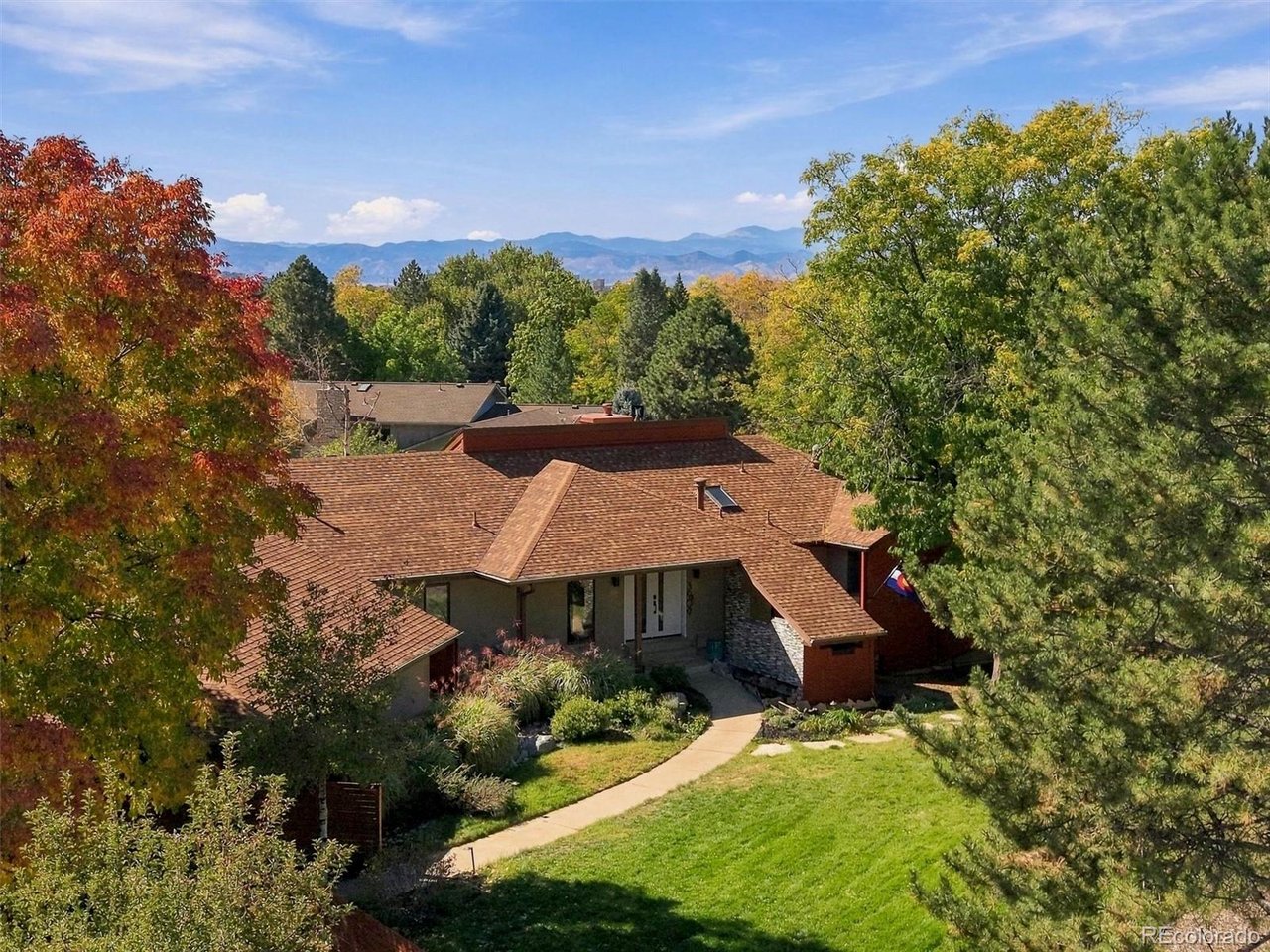 ASSUMABLE VA LOAN for qualified VA-eligible buyers! An exceptional opportunity in Meadow Hills Estates, a hidden-gem neighborhood of just 125 custom homes. This beautifully updated custom ranch with walkout basement sits on a spectacular 2/3-acre lot and offers exceptional spaces for entertaining, everyday living and multi-generational living. Pride of ownership is evident throughout. The spacious great room features a fireplace, a separate dining area and views of the beautifully landscaped backyard. The kitchen is a showstopper, featuring maple cabinets, quartz countertops, integrated Subzero refrigerator, an expansive island with bar refrigerator, and a generous butler's pantry. The spacious main-floor primary suite overlooks the backyard and opens to its own private deck with hot tub. The beautifully remodeled primary bath features new vanities, tile and fixtures, plus a heated floor. A large secondary bedroom with full bath round out the main floor. The walkout lower level dramatically expands the possibilities, with a family room with fireplace, three additional bedrooms, two baths, bonus room, second kitchen and additional laundry hookup. Interior stairs can be closed off, allowing the lower level to function as a completely separate living space-ideal for roommates, multi-generational living, extended guests, or exceptional entertaining space. Outdoor living is equally impressive. The beautifully landscaped 2/3-acre lot features a large deck with outdoor kitchen and fire pit, picturesque fish ponds with water lilies, expansive lawn and mature trees. An oversized, heated three-car garage offers additional room for a workshop. Enjoy the privacy and distinctive character of Meadow Hills Estates while remaining convenient to Cherry Creek Reservoir, the Denver Tech Center, Park Meadows shopping and dining, Denver International Airport and the mountains. A rare combination of custom design, extensive updates, flexible living spaces and an extraordinary setting.