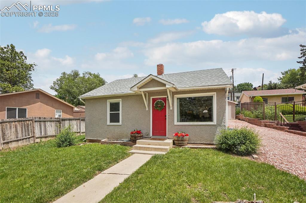 Welcome to this picture-perfect bungalow, where classic charm meets cozy comfort. The cheerful red front door and inviting curb appeal set the tone, while a bright interior with a large picture window fills the living space with natural light. Inside, enjoy tasteful updates and fresh, modern style throughout. Gleaming hardwood floors flow throughout, creating a warm and inviting atmosphere from the moment you enter. The open living room is stylish and cozy—perfect for relaxing or entertaining—with sleek finishes and on-trend design elements that make the space feel both contemporary and timeless. The kitchen is a true showstopper—bright, functional, and full of personality. With updated cabinetry, chic tile work, and modern fixtures, it’s the perfect blend of form and function. Both bedrooms are light-filled and comfortable, offering the ideal retreat at the end of the day. The home sits on a spacious lot, offering plenty of room to garden, entertain, or simply relax in your private, fenced yard. Ideal for first-time buyers, down-sizers, or investors, this home features timeless exterior finishes, central A/C, and a long driveway leading to a detached two-car garage for off-street parking. Perfectly located just minutes from Old Colorado City, downtown, and I-25 access, you’ll enjoy the convenience of city living with the peaceful feel of a quiet neighborhood.