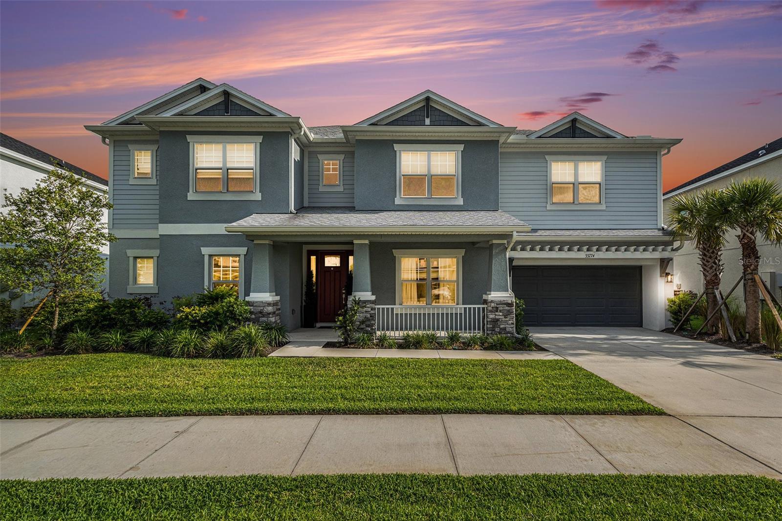 Turn-key and better than new, this stunning 2023 Taylor Morrison Bimini model offers 4,217 square feet of thoughtfully designed modern Craftsman living in the highly sought-after, amenity-rich River Landing community. Situated on a premium 0.26-acre homesite with no rear neighbors, this exceptional residence overlooks a tranquil pond and mature conservation views, providing both privacy and picturesque scenery. Designed for COMFORT AND LUXURY, the home features 5 spacious bedrooms, 4.5 bathrooms, and a versatile two-story floor plan with the primary suite conveniently located on the main level, along with an additional en-suite bedroom upstairs, perfect for guests or multigenerational living. The heart of the home is the GOURMET CHEF’S KITCHEN, showcasing an oversized island, premium finishes, and abundant space for gathering and entertaining. Additional highlights include a spacious loft, dedicated media room, office, generously sized secondary bedrooms, and ample storage throughout. Step outside to your private BACKYARD RETREAT featuring an enclosed heated pool and spa, extended covered lanai, and a fully equipped OUTDOOR KITCHEN, creating the ultimate setting for year-round Florida living and entertaining. With countless upgrades throughout, this meticulously maintained  home offers the luxury lifestyle today's buyers desire without the wait of new construction. Residents enjoy access to The River Club, a resort-style amenity center featuring a sparkling pool and spa, a covered fire pit gathering area, sports fields, tennis and pickleball courts, playgrounds, pet-friendly parks, and scenic walking and biking trail, offering endless opportunities for recreation, relaxation, and an active outdoor lifestyle. Ideally located near premier shopping, dining, Tampa International Airport, top-rated hospitals, the outlet mall and top schools. Why wait to build when you can move right into this remarkable, like-new home and start enjoying Florida living at its finest.