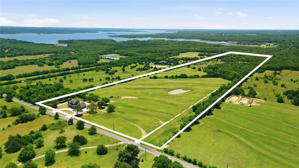 STUNNING NEW CONSTRUCTION ON 46+ ACRES NEAR LAKE TEXOMA BACKING UP TO CORP LAND WITH AG EXEMPTION! Experience the pinnacle of luxury, privacy,& country living in this brand-new architectural masterpiece. This property seamlessly blends ultra-high-end modern living with an uncompromised agricultural lifestyle. Built to absolute perfection, no expense was spared in crafting this custom home. Every detail showcases premium quality & meticulous craftsmanship: Designer Kitchen & Baths: Loaded with upgraded custom cabinetry, elite stone countertops,& a professional-grade appliance package. Premium Finishes: Upgraded flooring, designer lighting,& high-end plumbing fixtures flow throughout the open layout. Luxury Master Suite features a private oasis. Home has tankless water heater for endless hot water. The rear of the property transitions into a dense, mature tree line offering unmatched privacy. Located close to Cedar Mills Marina & Walnut Creek Marina!