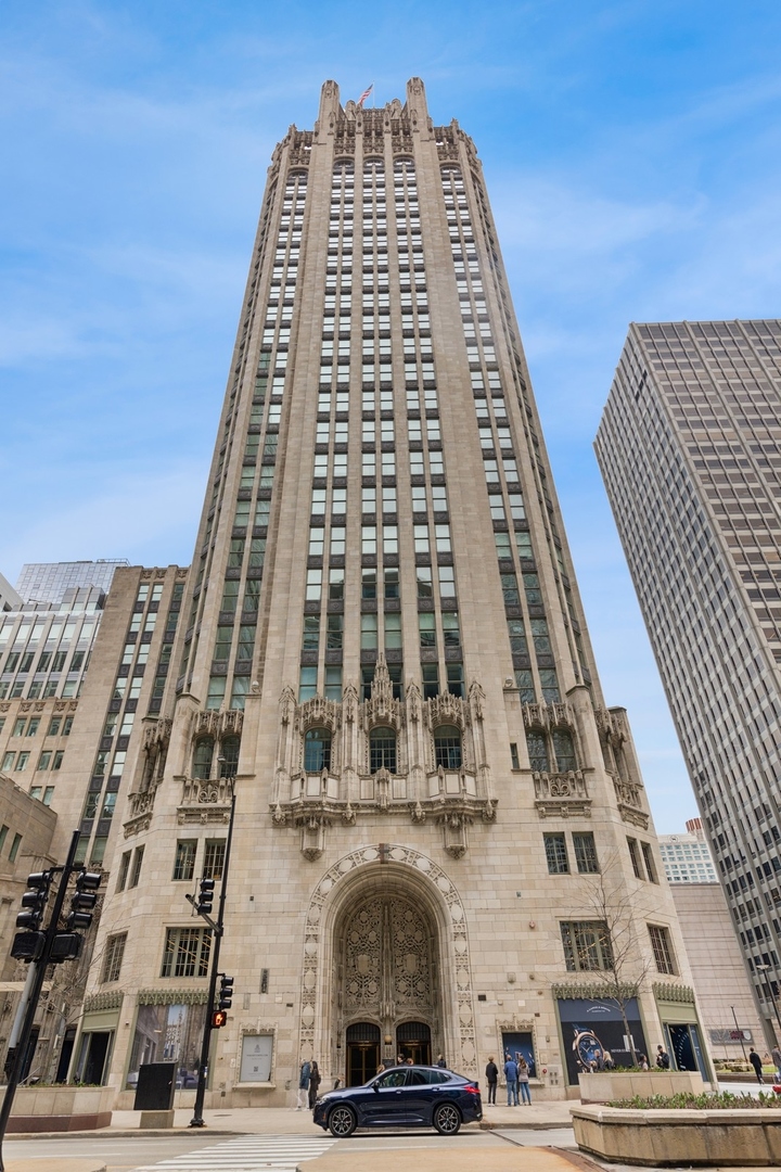 Live in one of Chicago's most iconic buildings at Tribune Tower Residences. This beautifully designed 1-bedroom, 1.1-bath home with a flexible library space spans 1,700 sq. ft. and offers courtyard views and high-end finishes throughout. The open-concept living, dining, and kitchen area leads to a private balcony-perfect for relaxing or entertaining. The chef's kitchen is outfitted with classic Bovelli cabinetry, quartzite countertops and backsplash, Wolf, Sub-Zero, and Miele appliances, built-in smart technology, a custom range hood, and island seating for four. Floor-to-ceiling windows bring in great natural light, complementing the wide-plank oak hardwood floors throughout. The custom library with barn-style doors, designed by Bovelli Millwork, adds character and works well as an office or guest space. The spacious primary suite with its spa-like bath featuring quartz finishes, dual sinks, a soaking tub, and a separate shower. Additional features include in-unit laundry with built-in shelving, surround sound, custom storage, and motorized shades. Residents enjoy 24/7 staff and an unmatched suite of amenities: fitness center, indoor pool, outdoor terrace, putting green, golf simulator, and more. A rare chance to own a piece of Chicago history blended with modern comfort.