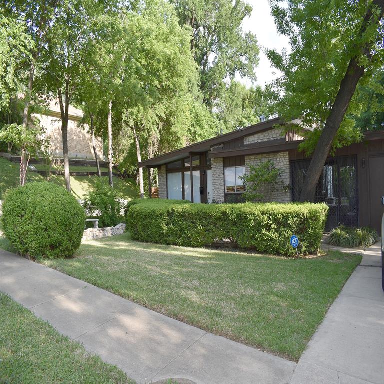 A unique opportunity in a fantastic Fort Worth location! 4709 Driskell Blvd offers a move-in ready main home plus a separate garage-conversion ADU, creating flexible options for multi-generational living, guest quarters, or potential rental income. Live in one and lease the other, or explore the possibilities of utilizing both spaces as income-producing property.The approximately 1,096 SF main home features 3 bedrooms, 2 full baths and a charming mid-century modern vibe with inviting curb appeal. Inside, you’ll find comfortable living and dining spaces, a charming kitchen, central HVAC and a primary suite with a private bath featuring both a soaking tub and separate shower.The approximately 450 SF ADU offers an additional 1 bedroom and 1 bath, efficiency kitchen, mini-split HVAC, washer-dryer connections and its own private side yard. Both living spaces have separate laundry connections and thoughtfully designed outdoor areas with mature trees and privacy fencing.Located in an established Fort Worth neighborhood, this property puts you close to shopping, dining, entertainment, major roadways and many of the attractions that make Fort Worth such a desirable place to live. Whether you’re looking for a primary residence with additional income potential, space for extended family, or a property with multiple living options, this one deserves a look.An FHA assumable loan may be available for a qualified buyer, subject to lender approval and applicable requirements. Furnishings are also available for purchase separately from the real estate. Move-in ready, full of character and offering possibilities you don’t find every day—don’t miss your chance to own a slice of Fort Worth!  FHA Assumable mortgage for qualified buyer - 4.75% interest rate.