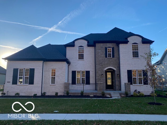 A perfect harmony of elegance and livability, this stunning Monticello design captures timeless style and modern comfort. Set on a serene tree-lined homesite, the home welcomes you with a charming front courtyard, offering a beautiful first impression and a peaceful place to relax. Inside, the open and airy layout reveals a breathtaking family room with a dropped tray ceiling and a cultured stone fireplace-a showpiece that exudes warmth and sophistication. The gourmet kitchen shines with quartz countertops, a pot filler, and custom cabinetry, seamlessly connecting to the casual dining area for effortless entertaining.  The independent living suite on the main level provides versatility for guests or multi-generational living, complete with a kitcheonette and space for an under-counter refrigerator. Nearby, a dedicated home office and formal dining room add both function and elegance to the main floor's thoughtful design. Upstairs, three spacious bedrooms 1 with a private bath and the others share a jack and jill. The primary suite is a true sanctuary, highlighted by a spa-inspired bath and refined finishes throughout. Step outside to enjoy the outdoor living area with a cozy fireplace, where evenings are best spent taking in the peaceful pond view. Every detail of this home has been intentionally crafted-from the architectural flow to the designer finishes-creating a space that feels both luxurious and inviting, inside and out.