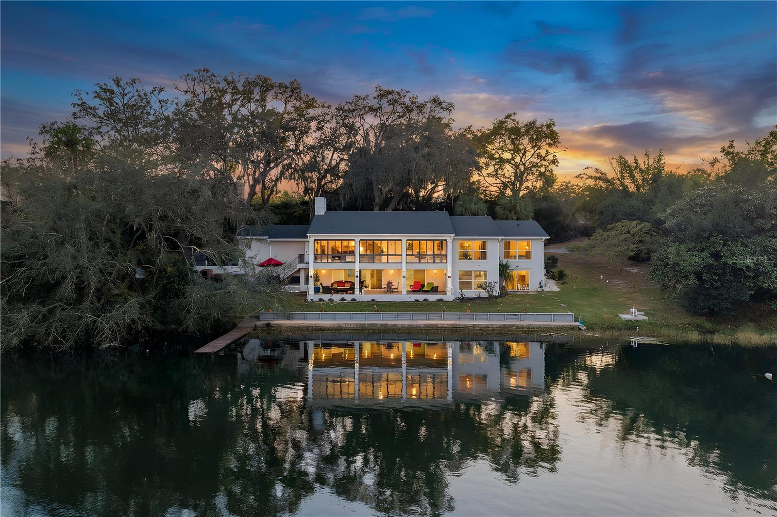 Love where you live. Completely renovated (2025) lakefront living on the private, skiable waters of Lake Louise - just minutes from downtown Mount Dora’s charming shops, dining, and year-round events, yet tucked away in your own peaceful waterfront sanctuary.Situated on nearly an acre with mature landscaping, this thoughtfully updated home offers expansive water views from nearly every room. Each morning, the sun rises over the lake, creating a breathtaking backdrop to start your day from the Florida room, living areas, and primary suite.The main level features oversized 24x48 porcelain tile throughout and walls of floor to ceiling windows that fill the home with natural light. The fully remodeled kitchen showcases porcelain countertops and backsplash, new cabinetry, high-end Samsung appliances, a premium LG dishwasher, and a large walk-in pantry.The primary suite has been completely renovated and includes a spacious walk-in closet, dual sinks, and a beautifully designed walk-in shower. A secondary bedroom on the main level also features a walk-in closet. The home also boasts an office/den on the main floor.The air-conditioned Florida room spans the rear of the home with floor-to-ceiling lake views, creating seamless indoor-outdoor living and one of the most captivating spaces in the home.The finished lower level offers luxury vinyl plank flooring, an expansive flex space perfect for a game room, media room, or gym, along with two bedrooms with lake views and a bathroom featuring a tub/shower combination.Additional highlights include: • 2025 roof • Recently redone concrete seawall • Wood dock • Outdoor kitchen • Wood-burning fireplace • Indoor laundry • Two-car garage with extra storage and attic space • 4-year-old shed • Stunning magnolia tree & Avocado tree •Lake Louise is a private 19-acre skiable lake ideal for boating, paddleboarding or kayaking. Homes like this rarely become available. Contact me today for a private showing!