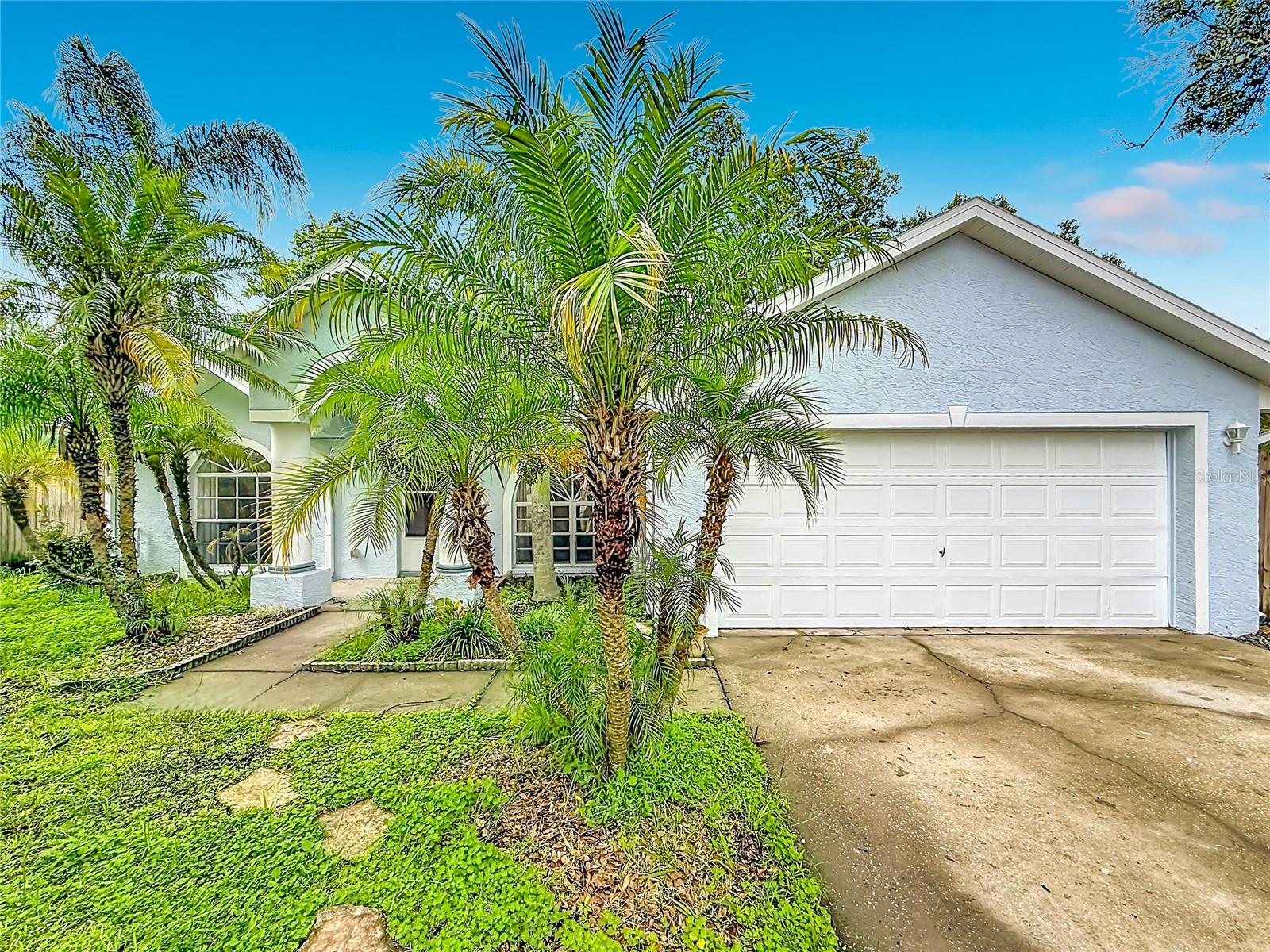 Virtually Staged. Sunshine, palm trees, and the Florida lifestyle—what more could you ask for? This beautifully maintained 3-bedroom, 2-bath home with a 2-car garage and NO HOA is ready for its next owner. Recently professionally painted inside and out, this move-in-ready home features tile flooring throughout with NO CARPET, vaulted ceilings, ceiling fans, and a desirable split-bedroom floor plan. The spacious primary suite includes a walk-in closet and private bath with a tiled walk-in shower, while the kitchen features stainless steel appliances and plenty of space for everyday living. Step outside to enjoy mature trees, a wood-fenced backyard, freshly painted storage shed, and a patio area offering the perfect spot for outdoor entertaining, relaxing, or gathering around a fire pit. The spacious driveway provides plenty of parking, while the garage features an insulated garage door and space for the washer and dryer, which are included. Additional exterior features include gutters and mature landscaping that add to the home's well-kept appeal. Major updates include a NEW A/C system in 2025, roof replaced in 2019, and electric water heater replaced in 2018. Best of all, you're approximately 25 minutes from the beautiful Gulf beaches, with shopping, dining, entertainment, medical facilities, schools, and everyday conveniences all close by. Clean, updated, well cared for, and ready for its next owner, this Pinellas Park home is a must-see!
