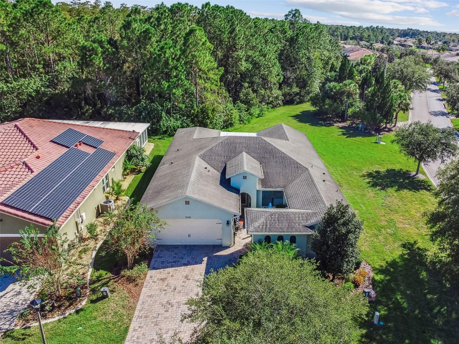 One or more photo(s) has been virtually staged. Located near The Palms Resort Amenity Center, this beautifully appointed Naples Model (2.956 Sq Ft) offers the perfect blend of comfort, style, and functionality. Designed for both everyday living and effortless entertaining, this spacious home sits on a premium corner lot with tranquil conservation views. Step into the private courtyard, an inviting outdoor retreat ideal for relaxing or gardening. Enter through the leaded glass front door into a bright and open living space featuring 18-inch ceramic tile floors throughout the main areas, custom illusion blinds, and a vaulted ceiling with a Minka ceiling fan. The Great Room, framed by custom drapes and conservation views, flows seamlessly into the Dining Room, where you’ll find an elegant chandelier, crown molding, and tailored window treatments. The living area extends into the enclosed 4-season room with a conservation view adding versatile space for year-round enjoyment. The chef’s kitchen is both stylish and functional, offering: A breakfast nook and island/bar with pendant and recessed lighting, Stainless steel appliances, including a 2024 LG 4-door Smart Refrigerator with extended warranty, Tile backsplash & under-cabinet lighting, 24 full-extension pull-out drawers, deep double sink with upgraded faucet, and Large walk-in pantry plus Butler’s pantry. The Primary Suite is an oversized retreat with luxury vinyl plank flooring, an expansive (WOW) customized walk-in closet with drawers, bench seating, and overhead storage. The en-suite bath features a walk-in shower with seat, dual sinks, wall-to-wall cabinetry with pull-outs, and custom lighting. On the opposite side of the home, the Guest Suite offers privacy with its own flexible office/sitting area with built-in shelving and a private bath featuring a walk-in shower, upgraded fixtures, and custom cabinetry with pull-outs drawers. Additional upgrades include: "Easy on the back" full extension pull-out drawers throughout the kitchen and both bathrooms. A Laundry room with custom cabinets and sink. 2-car garage with epoxy flooring, built-in shelving,  overhead storage and an extra refrigerator.  Also, a much desired separate golf cart garage. This exceptional home is a quick close, move-in ready and offers the ideal combination of thoughtful upgrades, spacious design, and a highly desirable location close to Solivita’s resort-style amenities.  Solivita offers residents access to state of the art amenities and work out facilities, dance and aerobics studios, a business center, 14 heated swimming pools, 2 heated spas, tennis courts, pickleball courts, shuffleboard, bocce ball, billiards room, art gallery, 3 restaurants and 2 championship 18-hole golf courses, driving range and putting course. Every day offers something new to explore and enjoy! This home also features easy access to nearby shops,as well as a brand new shopping center that caters to all your needs (including Sprouts) dining, and health care, offering the perfect balance of privacy and lifestyle.