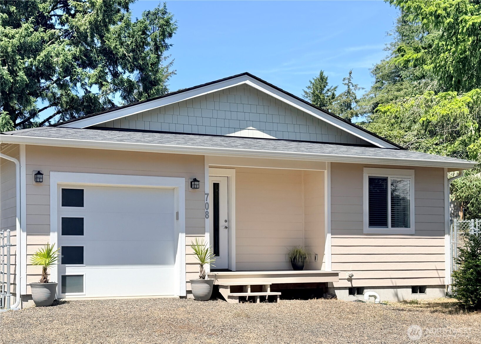 This craftsman home has a contemporary style and spacious feel. Meticulously maintained, this home looks brand new. The open concept layout has a seamless flow to the 2 bedrooms, and features Vaulted Ceilings in the living room and kitchen. Temperature stays cozy or cool with a Ductless Mini-Split and additional wall heaters in the bedroom as an optional heat source. Continuing through every room you will find Luxury Vinyl Plank flooring providing durability style and convenience. The kitchen is complimented with crisp white cabinetry, Quartz countertops and Stainless Steel appliances, while the wood-topped Island table offers a place to prepare meals and gather. The attached garage is extra deep, allowing you for ample storage space. Outside, the spacious backyard features an expansive concrete stamped Patio that provides generous space for entertaining or relaxing. Plus, the backyard is enclosed with a 6' chain link Fence, beneficial for pets, gardening and watching the deer pass by the back of the property. Come home to the peace and quiet of being nestled on a Cul-de-sac, yet still catch the Ocean breeze and the faint sound of the waves. Nearby you' will find Bill Ellis Memorial Park with access to Duck Lake. This home would make the perfect vacation get-away as well as a primary coastal residence.