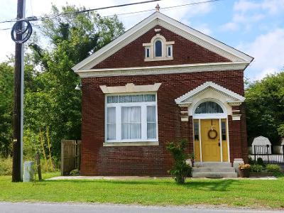 Bank built in 1920, A Brick dwelling w/Marble inlays marble entrance steps, ornate delicate tin ceilings & walls, original stained glass windows & glass chandelier in foyer, tall windows on main level with stained glass, gleaming hardwood floors, walls have brick, wainscoting, ornate decorative tin, wood, 2nd BR loft overlooking the kitchen area. Ceilings are HIGH giving a bright and airy flow throughout. Original transom bank windows separating kitchen/dining area, double wooden door full bathrooms off kitchen. Main level BR has THE VAULT which is being used as additional sleeping for guests. NOTE: AS IS Where IS and furnishings are not included but can be negotiated. Refrigerator, dishwasher, washer and dryer are included in purchase. Year Round Living or Short Term Rental Possibilities.