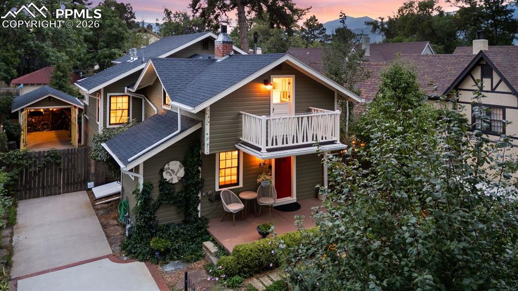 Historic-Renovated-Character. Nestled on a tree-lined street in the historic Old North End, this beautifully restored 1923 residence offers timeless character paired with modern living and lifestyle options. Why travel to a spa when you can live at one? Enjoy a hot tub, steam shower, and tranquil water feature right at home. Completely renovated in 2017 with new mechanical and plumbing systems, this property showcases high-end systems and finishes throughout. The main level features hardwood floors, an inviting living room, a powder room, & a spacious open kitchen anchored by a large island, stainless steel appliances, and a gas fireplace. French glass doors open to a private backyard with mature perennial gardens and a serene water feature—perfect for quiet mornings or evening gatherings. A unique lock-off studio at the front of the home offers a separate one-bedroom, one-bath living space that has been rented short-term on Airbnb and VRBO, providing excellent income potential for an owner-occupant. Upstairs, the primary suite is a true retreat with vaulted ceilings, a private deck with mountain views, a gas fireplace, and a spa-like bathroom featuring radiant heated floors, double vanities, a soaking tub, and a walk-in steam shower. A conveniently located laundry room adjoins the suite and includes a charming Dutch door opening to the front balcony for fresh air and views. The lower level provides flexible space ideal for a third bedroom and/or office, complete with a large walk-in closet, plus an immaculate storage and mechanical room. Additional features include a five-zone boiler hot water heating system, multiple mini-split AC units, two gas fireplaces, and a hot tub in the private side yard. A detached one-car garage offers secure parking and storage for bikes, skis, and other Colorado gear. All just moments from downtown Colorado Springs, Colorado College, Penrose Main Hospital, and Monument Valley Park trails—this is Old North End living at its finest.