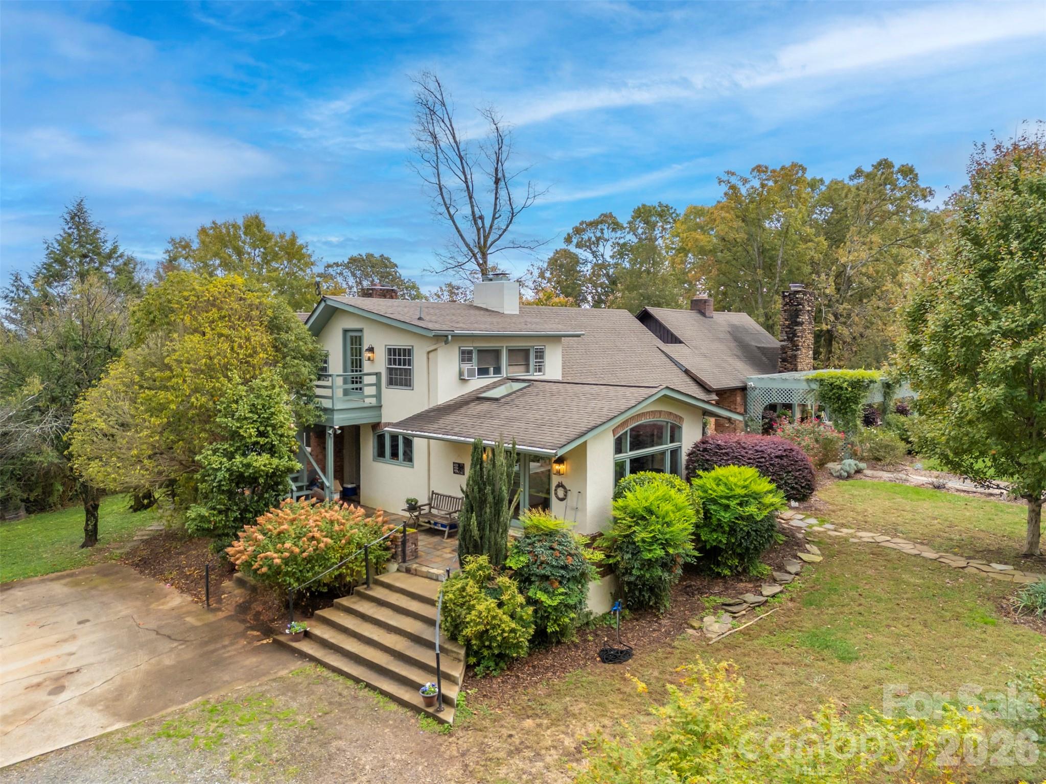 A timeless Tryon estate blending historic craftsmanship with modern comfort on 13.77 acres. Originallyan 1880 two-room dog-trot log cabin, the home evolved through a 1927 expansion and a 1963modern addition that introduced vaulted ceilings and open living spaces. The main residence offers3,194 heated square feet plus a 340-square-foot loft suite, complemented by a separate1,203-square-foot two-bedroom guest house. Features include three fireplaces, a great room withstone chimney, pine floors, and a brand new heat pump. Outdoor living areas feature two patios,tiered gardens, and a pool with new liner. Equestrian amenities include a three-stall barn, tack andfeed rooms, multiple fenced pastures, a dry lot, and easy access to the FETA trail system.