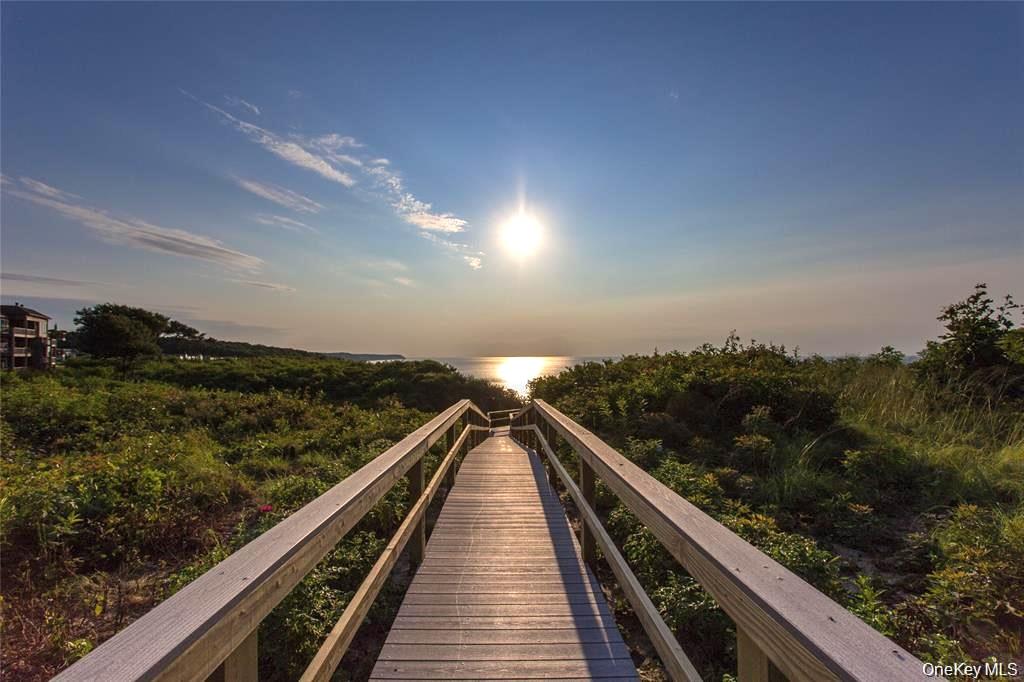 Welcome to your oasis at 3105 Bluff Drive S, Baiting Hollow NY, nestled in the waterfront community of The Knolls at Fox Hill. This spacious two-bedroom, two-bathroom unit offers ample room to relax, work, and entertain.Step into an open-plan living area, where natural light floods in through sliding doors that open to a covered balcony. Here, enjoy breathtaking views of the Long Island Sound and stunning sunsets. The kitchen and dining area flow seamlessly from the living room, perfect for hosting intimate gatherings.Each bedroom has sliders that open to a balcony. The expansive primary bedroom features three closets and a generously updated ensuite, while the second bathroom has also been recently modernized. A bonus den/office space provides flexibility for your lifestyle needs.  Additional conveniences include an in-unit laundry room, a one-car garage, and a large storage room. The community amenities are sure to impress - an Olympic-sized in-ground swimming pool, three tennis courts, a pickleball court, bocce ball, and a children's playground. Golf enthusiasts will appreciate the proximity to a world-class golf course.  Embrace the local lifestyle with easy access to a variety of shopping options, including Tanger Outlets, the Long Island Aquarium, fine dining establishments, vineyards, farm stands, and breweries. With the Hamptons less than a half-hour away and the city just 90 minutes away, this location offers the perfect blend of tranquility and accessibility.  Currently priced to sell! Don't miss this unique opportunity to live in a vibrant community with unbeatable amenities and stunning views. Your new home awaits!