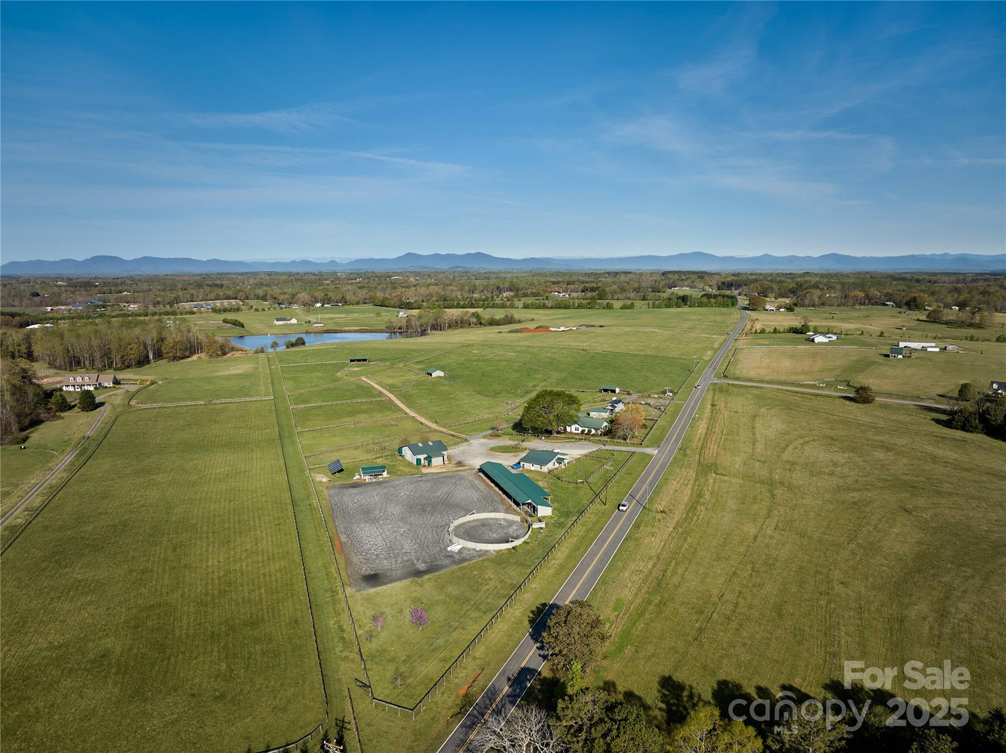 Discover timeless elegance and modern comfort in this beautifully restored 1929 home nestled on 20 fully fenced acres with 2 barns. This unique property offers the best of country living with high-end equestrian facilities, incredible views, and modern conveniences—an exceptional opportunity to own a turnkey horse property in the heart of NC horse country. Renovated to the studs in 2013, this home blends classic charm with updated sophistication, from beadboard ceilings, hardwood floors to curated modern touches in the primary, kitchen, and baths. Multiple turnouts, run-ins, hacking lanes, and a shared pond. Round pen and a large arena, circle drive for large rig access and parking. 4-stall center aisle barn with loft, washrack, feedroom, shaving storage. 8+ stall shed row barn includes tackroom, 2 tacking stalls, washrack, & equipment storage. Layout has been designed for true efficiency and ease. Just 15 minutes to TIEC. 40 mins to Greenville-Spartanburg Intl Airport.