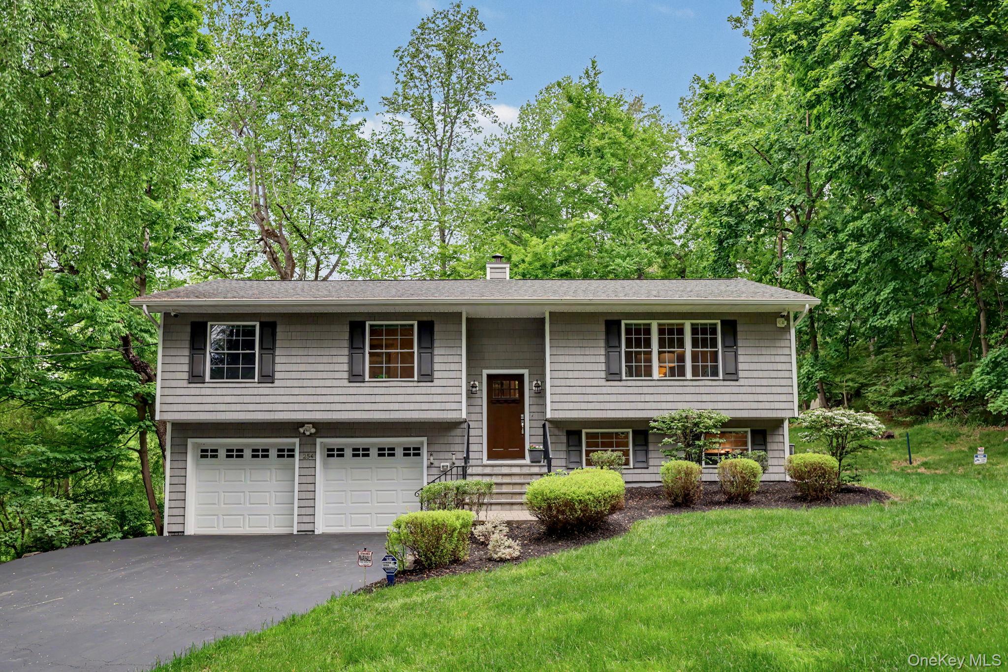 Young, beautifully renovated, and truly turnkey, this warm and inviting 4-bedroom, 2.5-bath home offers stylish updates, comfortable living spaces, and a flexible layout.  Originally renovated 10 years ago, the home has continued to be thoughtfully improved with many recent upgrades throughout. The main level features hardwood floors, an updated eat-in kitchen with white cabinetry, quartz countertops, tiled backsplash, stainless steel appliances, and access to the rear deck—perfect for everyday living and entertaining. A formal dining room, spacious living areas, and a primary suite with an updated walk-in shower add to the home’s appeal. The walk-out lower level offers a large family room, powder room, and fourth bedroom ideal for guests, office space, or extended living. A spacious 2-car garage provides additional convenience and storage. Recent improvements include a new post-and-rail fence, bluestone patio, security and camera system,  and new front and rear stairs, along with many exterior enhancements that add charm and curb appeal. Additional upgrades completed during the renovation include updated baths, central air, electric, plumbing, windows, roof, siding, driveway, lighting, walkways, landscaping, deck, and railings. Low taxes and access to a beautiful private community lake within a short distance make this home even more special. Conveniently located near Charles Cook Pool (mini golf & fitness trails), schools, shopping, parks, and the Cortlandt Train Station with approximately a 50-minute commute to Grand Central Terminal.