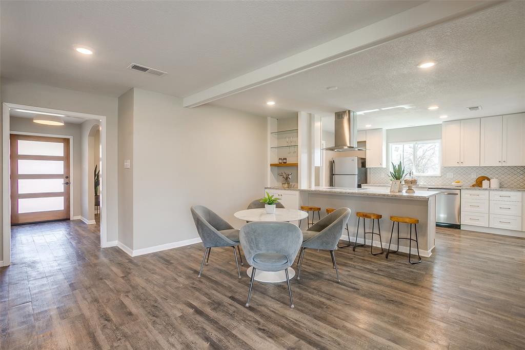 Welcome to your forever home in the highly sought-after Ridglea Hills neighborhood. This thoughtfully renovated property features a highly flexible layout specifically tailored for effortless family living and entertaining. The oversized front entry space easily transitions into a formal living area, large dining room, or a dedicated open-concept family zone. The functional kitchen opens directly into a secondary dining area and a warm family room anchored by a gas fireplace—perfect for a playroom or a cozy den to watch the kids. A separate bonus room easily transforms into a private home office, kids' crafting zone, or a convenient home fitness studio. The chef-inspired kitchen showcases soft-close cabinetry, striking arabesque tile backsplashes, granite countertops, and premium stainless-steel appliances accented by contemporary gold tones. Primary retreat features two generous walk-in closets and a magazine-worthy en-suite bathroom complete with a custom glass-tile shower, double vanity, and modern LED backlit mirrors. Bright secondary bedrooms flank a beautifully updated hall bathroom, with one bedroom boasting its own double walk-in closets for maximum storage. A fully gated and fenced backyard offers space for various activities, highlighted by a pergola-covered patio for weekend gatherings. Includes a massive 20x16 storage building, an attached carport, and unique, separated garage bays that offer the ultimate flexibility for a workshop, home gym, or extra vehicle storage. Move-in ready with brand-new insulation, durable, continuous vinyl wood flooring through all main living spaces, and abundant storage throughout. Enjoy seamless daily routines with quick access to Highway 183 and Vickery Boulevard, placing premier local retail, dining, and family entertainment right at your fingertips. Commuters will love the convenient 12-minute drive to the Texas Christian University campus. ALSO AVAILABLE FOR LEASE.