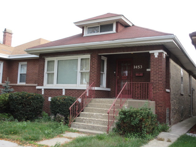 OFFERED AS-IS AT $299,900. Brick Chicago bungalow built in 1921, located in Chicago's Austin community. This 1.5-story residence offers eight rooms, including five bedrooms as currently configured and one full bathroom. The main level includes a living room, separate dining room, bedrooms, kitchen with walk-in pantry, hardwood flooring and original interior wood trim. The finished attic provides two additional bedrooms with closets. Public records do not identify the finished attic space in the reported square footage.    Additional features include a full unfinished basement with exterior access, an enclosed rear porch and a detached two-car garage with alley access. The property is situated on an approximately 3,840-square-foot lot.    The residence retains several original architectural features and requires repairs and updating. Property is being sold strictly AS-IS by the estate, with no seller repairs.    Located near Division Street, North Avenue and Cicero Avenue, with access to CTA bus routes, neighborhood retail establishments, restaurants, schools, parks and other community services. The area also provides connections to surrounding Chicago neighborhoods and major transportation corridors. La Follette Park is located at 1333 N. Laramie Ave. and the North Austin Chicago Public Library branch on North Ave.    Buyers are encouraged to verify room dimensions, square footage, bedroom configuration, permits and property information independently.