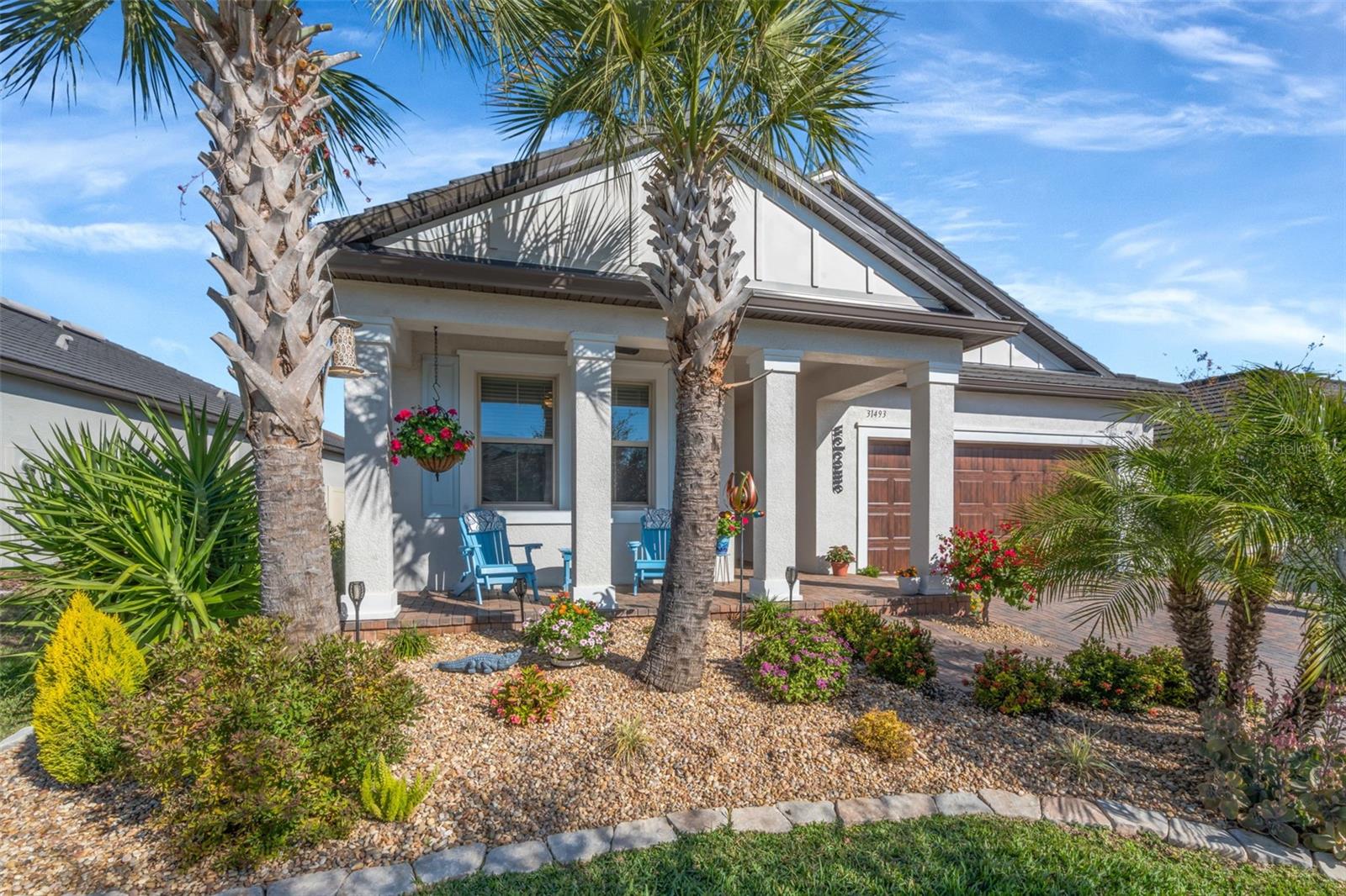 Luxury Florida Living, Elevated for the Active LifestyleWelcome to a lifestyle defined by comfort, connection, and coastal-inspired luxury in this beautifully appointed home located within one of Florida’s most desirable active adult (55+) communities. Thoughtfully designed for effortless living and refined entertaining, this residence blends upscale finishes with resort-style amenities—right outside your door.One of the home’s standout features is the enclosed, screened extended lanai, elegantly finished with custom pavers and designed as a true outdoor living destination. Complete with a mounted television and ample space for dining and lounging, this private retreat is ideal for alfresco meals, game-day gatherings, or relaxed evenings under the Florida sky—all overlooking a fully fenced, private backyard, offering both serenity and seclusion.Inside, the open-concept living areas are light-filled and welcoming, seamlessly connecting indoor comfort with outdoor enjoyment. Whether hosting friends or savoring quiet mornings, every space has been thoughtfully curated for ease, style, and functionality.The plush and spacious primary suite serves as a private sanctuary, thoughtfully designed with both luxury and convenience in mind. The spa-inspired primary bath features a split dual vanity with generous counter space and a dedicated sit-down makeup area, a private water closet, and an extra-large custom tile and glass walk-in shower that delivers a true resort-style experience. The primary closet offers a seamless pass-through connection to the laundry room, adding everyday ease and thoughtful flow to the home’s design.The home’s open-concept floor plan is elevated by carefully selected finishes, including stone countertops, designer wainscoting accents, a marble tile backsplash, and tile flooring throughout the main living areas, creating a clean, cohesive, and timeless aesthetic ideal for both daily living and entertaining.Beyond the home, residents enjoy a resort-style clubhouse featuring a sparkling pool, modern fitness center, on-site restaurant and bar, plus pickleball and tennis courts that encourage an active, social lifestyle. A golf-cart-friendly path leads directly to the breathtaking 15-acre Mirada Lagoon, where crystal-clear waters and sandy beaches create a one-of-a-kind Florida experience—without ever leaving the community.Conveniently located near shopping, dining, healthcare, and everyday essentials, this home offers the perfect balance of privacy, luxury, and lifestyle.This is more than a home—it’s your next chapter of living well, living active, and living beautifully in Florida.