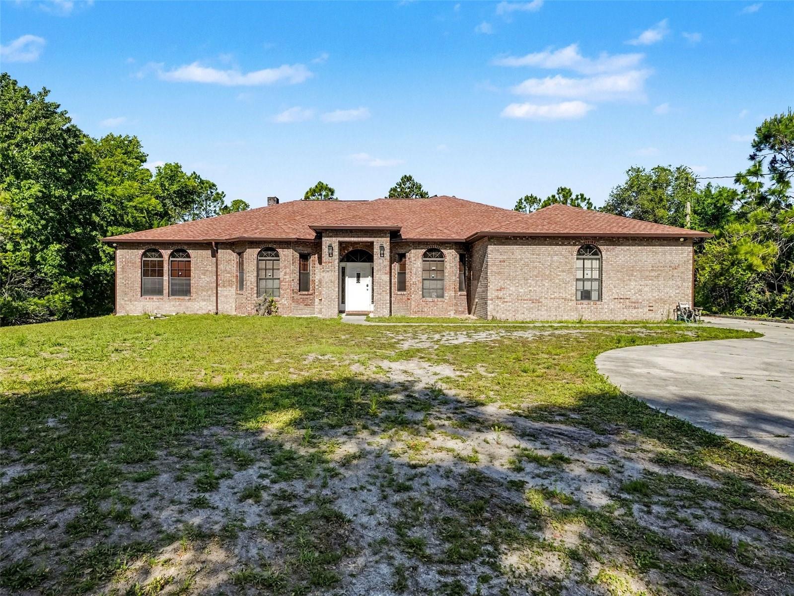 1.74 ACRES. NO HOA. BRICK CONSTRUCTION. SPACE + FUNCTION IN ORLANDO.Welcome to 3612 Bancroft Blvd — a rare opportunity to own nearly 1.75 acres in Orlando with the kind of privacy, space, and flexibility buyers are constantly searching for.From the moment you arrive, you feel the difference — wide open land, mature surroundings, and no HOA restrictions. Bring the boats, RVs, trailers — or simply enjoy the freedom and space that’s getting harder to find.Built with solid brick construction, this home offers durability and long-term value, paired with two A/C units for efficient comfort and a whole-home water filtration system already in place.Inside, the layout is designed for both everyday living and privacy. The primary suite is positioned on its own side of the home, complete with a private fireplace for a true retreat feel, while two additional bedrooms and a full bathroom are located on the opposite side — ideal for guests, family, or multi-generational living.The heart of the home is the spacious family room and kitchen combination, where the fireplace serves as a stunning focal point, creating a warm, inviting space perfect for gathering and entertaining.The kitchen features wood cabinetry, a functional center island for prep space, and upgraded stainless steel appliances, giving you both style and practicality without sacrificing flow.You’ll also find formal living and dining rooms, offering flexibility for hosting or additional living space.An indoor laundry room adds convenience, and the 3-car garage provides plenty of room for vehicles, storage, or a workshop setup.This isn’t just a home — it’s land, privacy, and a layout that truly works.Acreage. No HOA. Split floor plan. Statement living space. Upgraded kitchen.