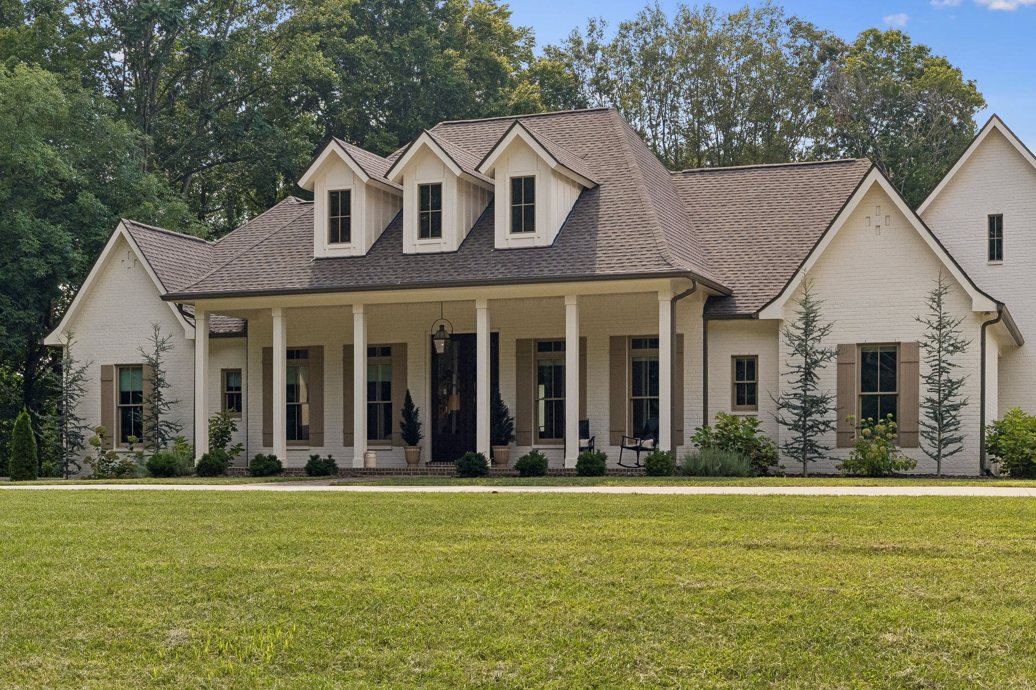 Welcome to one of Montgomery County’s premier luxury estates! Nestled on nearly 4 breathtaking acres in the highly sought-after Port Royal area, 4219 Sadlersville Rd offers an extraordinary blend of timeless craftsmanship, modern technology, and peaceful country living just minutes from Clarksville. This spectacular custom-built home features 8,123 sq. ft., 5 bedrooms, 4 full baths, and a half bath with an exceptional floor plan designed for both comfortable everyday living and grand-scale entertaining. Gorgeous covered porches overlook the beautiful grounds, creating incredible outdoor living spaces that are perfect for relaxing or hosting family and friends. Pictures truly speak a thousand words, but this is a home that must be experienced in person to fully appreciate the attention to detail. Features include soaring 10-foot ceilings, superior basement walls construction, aluminum-clad windows, grand walk-out sliding doors, custom interior shades, a stunning 100-year-old 3-inch thick red oak antique entry door with original hardware, Bevolo gas lantern, and an oversized 5-car garage with additional space for a workshop, hobby area, or home gym. The chef-inspired kitchen with luxury appliances, a 36-inch BlueStar dual-fuel gas range with pot filler, Quartz leathered countertops, and a spacious walk-in pantry. The luxurious primary suite offers dual custom-organized walk-in closets with direct access to the laundry room. Additional amenities include a whole-house water filtration system, reverse osmosis drinking water, Generac Generator, whole-home security system, hardwired WiFi 6 access points, hidden passageway, storm shelter/bunker, in-ground irrigation, gas fireplaces, and two laundry hookups. Enjoy an outdoor wood-burning fireplace, walk-out patio. Golf enthusiasts will love the Foresight GC Hawk Albatross simulator package. A rare opportunity.