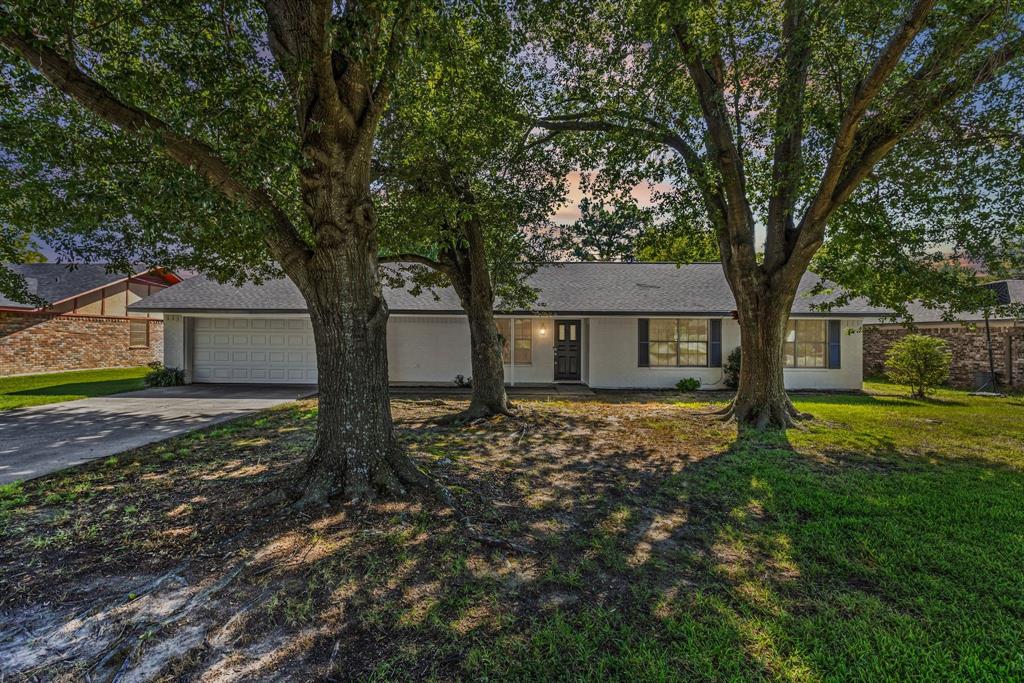 A tree-shaded lot gives tremendous curb appeal to this 3 bedroom, 2 bathroom with 2-car garage! After stepping inside the foyer, you'll notice the white-brick wood-burning fireplace in the vaulted-ceiling living room with wood beams and an eat-in dining area to the left. The kitchen includes a large u-shaped area with granite countertops, extra seating with a long breakfast bar, sleek-black subway tile backsplash, white cabinets, and stainless steel appliances. Double patio windows with a door in the living room, gives you access the shady backyard with privacy-wood fencing. Ceramic tile flooring is found in the living, dining, utility-mud room, and bathrooms. The primary bedroom comes with an ensuite bathroom that has a vanity seating area. Off the garage, you'll find a mud room and an enclosed utility area with shelving. Neutral paint colors provide a blank slate for your decorating ideas. Ceiling fans are also located in living room, dining area, and bedrooms. Park your cars in the attached 2-car garage or use the space as a game room, hobby space, or flex room. In an established neighborhood, this cute home with treed lot is also within walking distance to Lake Coleman, Coleman Park, walking trails, fishing, and picnic areas. A great home and location in town! (There is no refrigerator or Washer,Dryer with this home.)