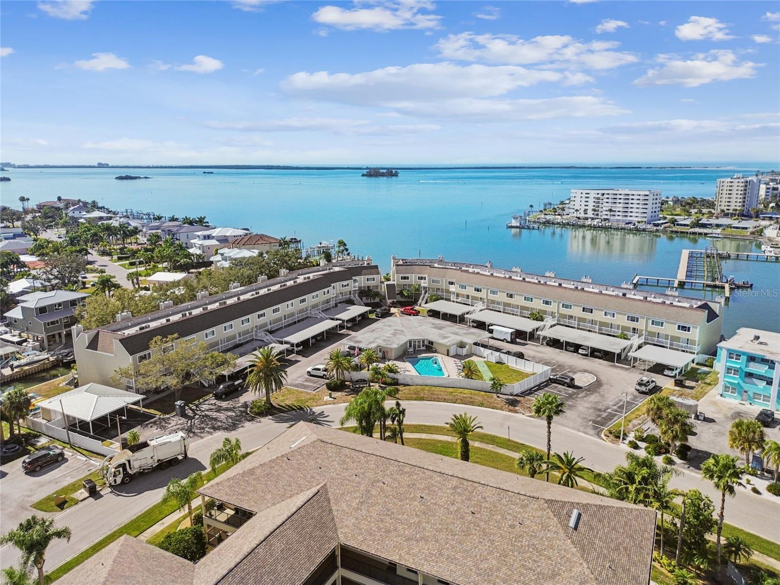 Location, Location, Location!!! Your carefree, maintenance free lifestyle awaits with unbeatable waterfront living in fabulous Dunedin…  Discover your slice of paradise in this immaculate, move-in ready, second-story condo, accessible via elevator, offering you a spacious 2 bedroom, and 2.5 baths as well as a covered carport space… just under 1,300 sq. ft. of pampered living.  Enter through the storm door to the main living area featuring a desirable open concept layout and boasting luxury vinyl flooring.  Gorgeous, fully remodeled kitchen flaunts white shaker-style, soft close cabinetry, a lazy-susan cabinet, pot hanger, granite counter, large undermount ss sink, designer tile backsplash, SS dishwasher, Café style ceran top range, built in microwave and refrigerator.  Laundry area is located just off the kitchen, and the sellers are generously including the washer and dryer with the sale of the home.  Kitchen overlooks to great room that is centered by a cozy wood burning fireplace and looks out through impact sliding glass doors to a fabulously canal view. Take in the serenity of the water on the new balcony with cable railing and decking to first floor!  For guests’ convenience the main floor also features a half bath with a posh cultured marble countered single vanity.  Both bedrooms are located on the second floor and feature their own ensuite.  Ideal split bedroom plan for privacy.  The primary bedroom features full wall closet, ceiling fan and fully remodeled ensuite boasting a large single vanity with undermount sink, full walk-in shower with floor to ceiling tile, niche, and glass door.  The home offers a true double primary with the second bedroom. It has a gorgeous ensuite bath with a single undermount sink and tub/shower combination with designer tilework.  Plenty of storage with upper closets, main floor under the staircase storage, as well as an additional storage closet at the carport.  Additional notable updates include water heater (2 yrs old), washer/dryer (2 yrs old), AC 2020, Electrical panel (2022), Impact windows and sliding glass door. This lovely condo is just steps from the refreshing community pool.  Condo fee includes grounds and building maintenance, exterior insurance, pool, sewer, water and trash.  Pet friendly community! The ultimate Florida lifestyle near sought after downtown Dunedin with its charming vibe and endless opportunities… restaurants, entertainment, breweries, shopping, festivals, Dunedin Golf Club, Pinellas Trail.  Near to medical, easy access to airports and of course the famed Gulf beaches are your backyard playground!  Your tropical paradise is waiting!