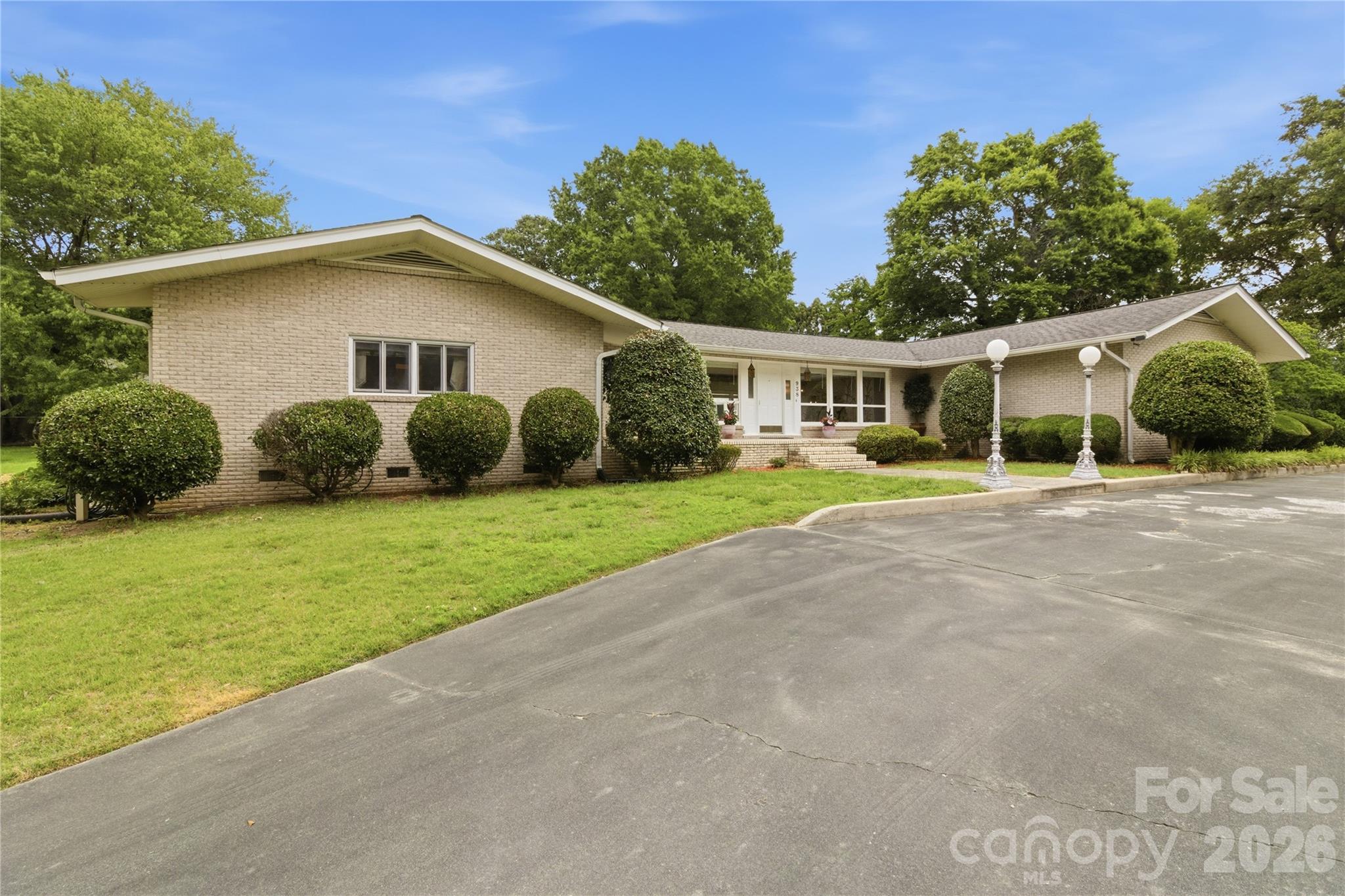 Tucked at the end of a quiet street in an established Gastonia neighborhood – custom mid-century homes on large lots, no HOA – this one-level ranch sits on nearly an acre and lives larger than you'd expect. Ahead of its time when built in 1967 and beautifully maintained ever since, it blends timeless mid-century character – exposed-beam ceilings and walls of windows – with a layout made for everyday comfort and easy entertaining.The dramatic step-down living and dining room centers on a stunning rock fireplace, while the kitchen opens to a spacious den warmed by a second fireplace. A pass-through serving window connects the kitchen to the pool, set in a private courtyard framed by the home – your own backyard retreat with a newer pump and Hayward filtration. Storage is generous throughout, including a spacious walk-in pantry and a mud/laundry room with full bath.3 bedrooms and 3 full baths include a primary suite, with ceramic-tile baths, a circular driveway, and a 2-car garage rounding out the home.Unbeatable location: less than a mile to the Schiele Museum and Gaston County Library, about a mile to the Catawba Creeks Greenway, and minutes to I-85, shopping, and dining. Crowders Mountain State Park is roughly 12 miles and Charlotte Douglas International Airport about 16 miles.