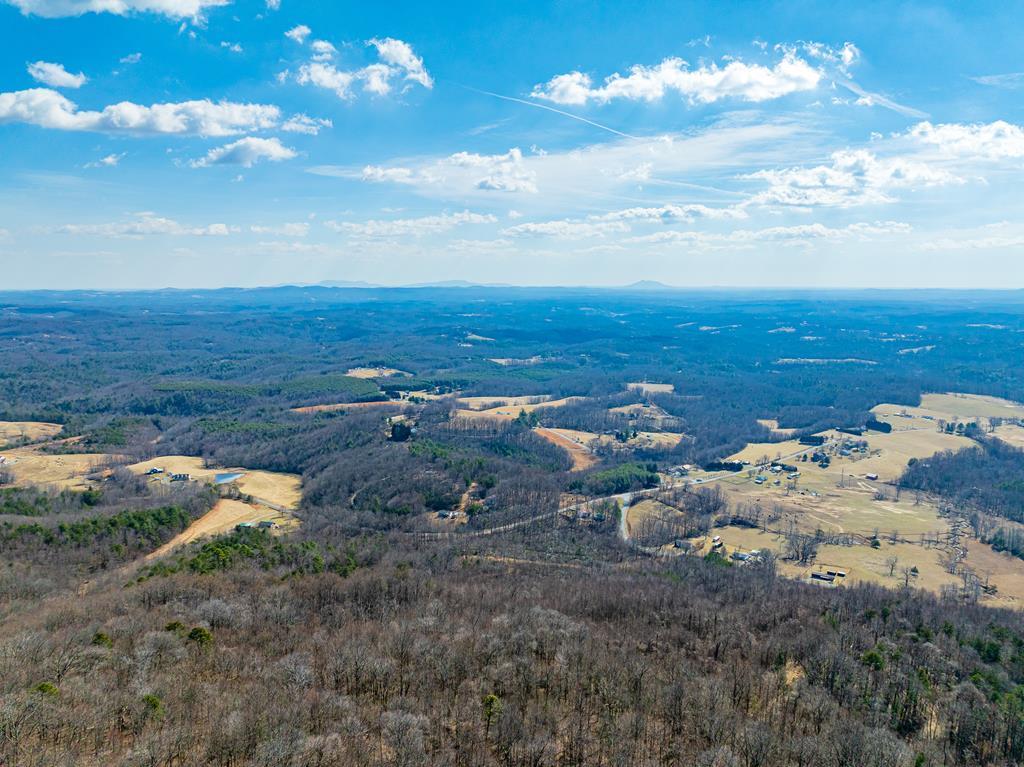 Lot 110 offers an incredible opportunity to own your own piece of the mountain at an affordable price. Whether you're looking for a long term investment, a future homesite, or a chance to get in on the ground floor of a growing mountain community, this property deserves a closer look. Enjoy breathtaking mountain views along with access to outstanding community amenities, including a stocked fishing pond, a scenic waterfall, and a charming covered bridge with a picnic area for family and friends to enjoy. The peaceful setting offers the perfect balance of privacy and convenience.  Located just 1 hour from Winston Salem, NC, 1 hour 17 minutes from Blacksburg, VA, 1 hour 30 minutes from Greensboro, NC, and 1 hour 48 minutes from Charlotte, NC. You'll also be less than 20 minutes from local grocery shopping and only 28 minutes from Mt. Airy, NC.  This lot has been surveyed by map only. Buyer may obtain a physical ground level survey at their own expense if desired. Inquire for more details about Lot 110 and available owner financing. This is your chance to secure a beautiful piece of the Blue Ridge before it's gone. This property does have light residential restrictions and is located within a subdivision.