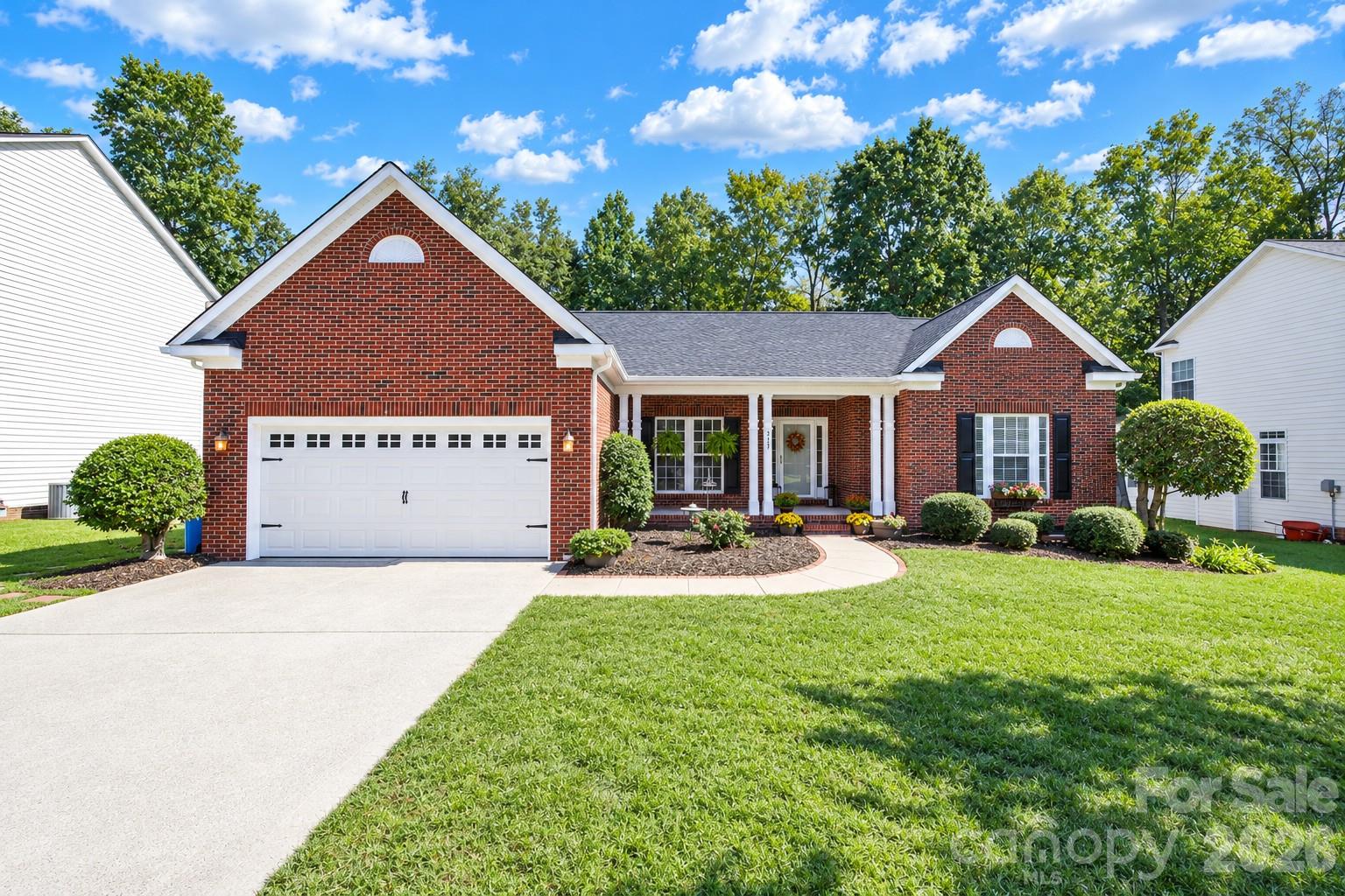 Prepare to Fall in Love with This Tastefully Updated, Move-In Ready Ranch in Sought-After Whitegrove!  This inviting 4-bedroom, 3-full-bath ranch offers the perfect blend of modern updates, comfortable living, and versatile spaces. The spacious, open-concept floorplan is designed for both everyday living and entertaining, while two primary suites provide exceptional flexibility for multigenerational living, overnight guests, or a private retreat. Updated wood-plank flooring flows throughout the home, creating a cohesive, contemporary feel.The thoughtfully appointed kitchen blends timeless charm with everyday functionality, featuring elegant raised-panel cabinetry, gorgeous soapstone countertops, and a classic subway tile backsplash. A generously sized, deep kitchen sink adds practicality, while the appealing finishes create a welcoming space for preparing meals, gathering with family, and entertaining friends.All three full bathrooms are beautifully updated, showcasing large-format tile flooring, sleek quartz countertops, classic subway tile showers, and new plumbing fixtures. The combination of stylish finishes and modern updates creates a fresh, spa-inspired feel throughout.The sunroom provides additional living space and the perfect spot to enjoy your morning coffee, unwind with a good book, or entertain guests. Additional highlights include a tankless water heater, updated plumbing supply lines, and ample storage throughout.Step outside to discover a spacious, wooded lot offering a wonderful sense of privacy. The backyard features a wood deck and charming brick patio, creating inviting spaces for outdoor dining, entertaining, or simply relaxing in a peaceful setting.Enjoy the benefits of Whitegrove's community amenities, including walking trails, a neighborhood pond, and a playground. Conveniently located near shopping, dining, entertainment, and I-485/I-77, this home also offers the added appeal of Fort Mill Schools.With its tasteful updates, flexible floorplan, beautifully renovated bathrooms, and private outdoor setting, this home is a wonderful opportunity to enjoy comfortable living in a sought-after community. Don't miss your chance to make this special home your own!