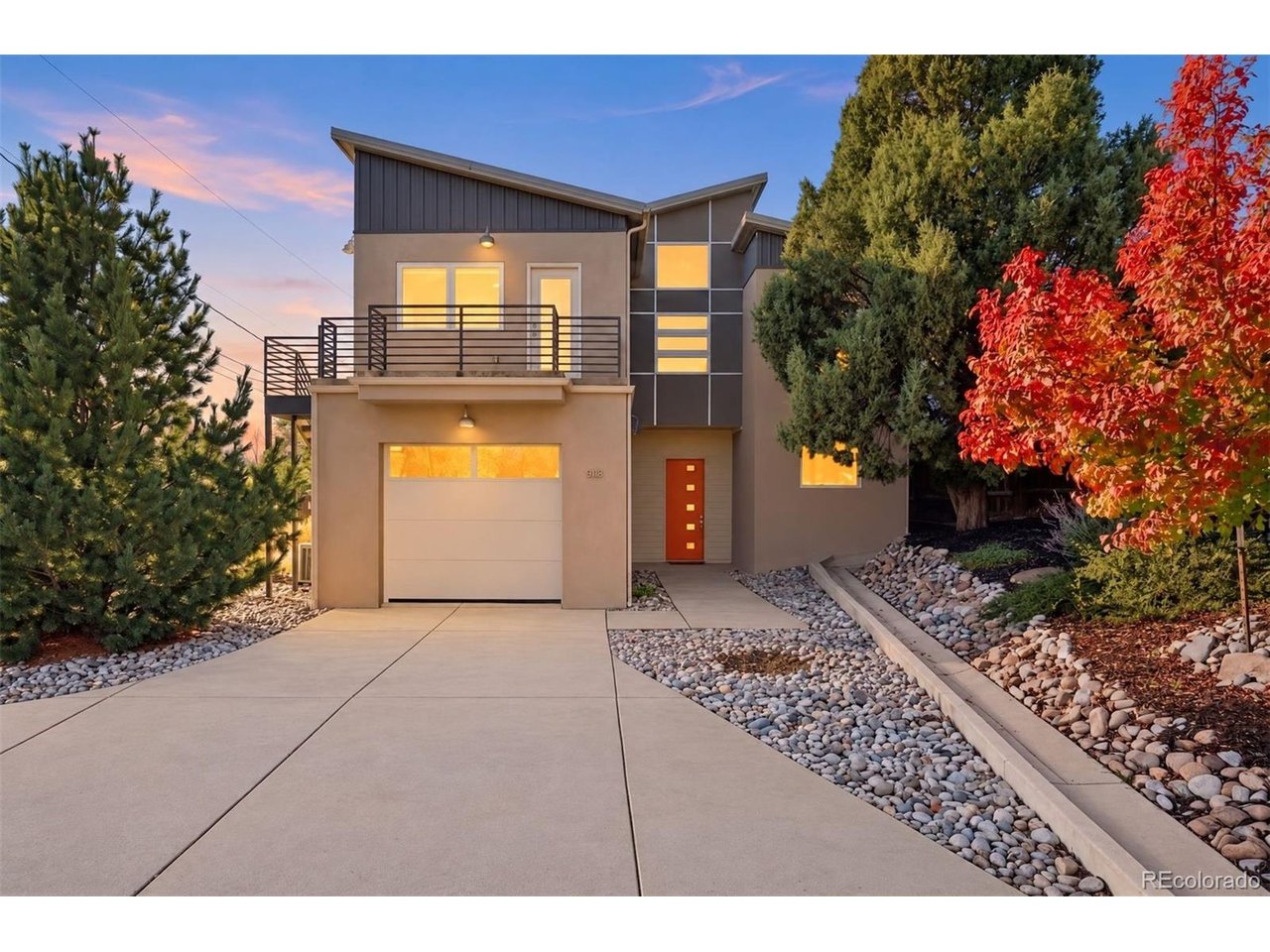 A true one-of-one creation, this elegant, architect-designed attached single-family home (no HOA) offers four spacious bedrooms, polished concrete floors, an upper-level balcony deck with separate street-level-accessed entrance, & 2 enclosed patios. Constructed of high-efficiency Insulated Concrete Forms (ICF), this is minutes from downtown via the Pike's Peak Greenway and close to the Mesa Valley Trail which connects all the way to Garden of the Gods. Ten-foot ceilings on the main level are accentuated by eight-foot doors. The generous living room offers incredible flexibility, operating as a hub for daily life with a gas fireplace, and a walkout to the enclosed east side patio. The modern, slab-faced cabinets in the kitchen offer an incredible amount of storage and are complimented by extensive quartzite counters. The gas range is ducted, and the wall oven and microwave add a sophisticated element to any evening's preparation. Out the back of the main level is another discreet patio that features a gas line connection. Two single-bay garages are each more than 22' deep with the main garage featuring a dramatic 9' door. Upstairs, brand-new carpet captures the sun-filled vision with a standout family room. This incredible space is perfect for media or hang time, with its own wet bar and vaulted ceilings. Alongside this room is a cavernous bedroom that doubles as an office. With a built-in armoire for storage, vaulted ceilings, and a separate entrance, this is perfect for small business owners or guest access. Two additional bedrooms share a full bath, and the laundry facilities are at the end of the hallway. The primary suite is set apart from the other bedrooms and has mountain views through up-down blinds, an 80 square foot walk-in closet with built-ins and its own armoire. Heated floor tile is found in the bath and a well-appointed shower. A new metal roof (November 2026) & 3-zone heating system bring life together with timeless intentionality.