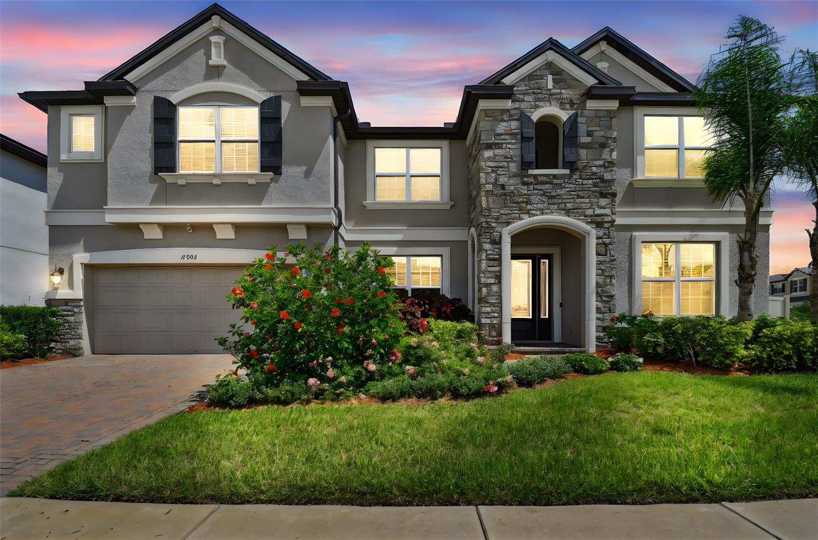 Get ready to fall in love with this practically brand-new, award-winning MI Home in the gated and private Sundrift community of K-Bar Ranch! Perfectly positioned on a premium corner lot, this 2021-built stunner offers partial water views and an expansive layout with over 5,500 sq ft of living space.
With 7 bedrooms (including one currently used as a media room), a den/office, and a massive loft complete with wet bar, there’s room for everyone and every activity. The home is completely carpet-free, featuring stylish, low-maintenance flooring throughout.
You’ll be greeted by lush, colorful landscaping—roses, mature palms, and more—leading to a grand entry with a custom 10-foot glass chandelier. Inside, the chef’s kitchen boasts 42” cabinetry, granite countertops, stainless appliances, double ovens, a walk-in pantry, and an oversized island.  The kitchen also features a breakfast bar and separate eat-in kitchen area. The formal dining room and office/den with French doors add flexibility and elegance.
The spacious owner’s suite is located downstairs with a spa-like ensuite bathroom featuring dual vanities, walk-in shower, garden tub, and dual custom-built closets. A tucked-away guest suite and full bath are also on the main floor in addition to a conveniently located half bathroom and large indoor laundry room. Upstairs features an expansive loft with a second full island, wine fridge, and additional living space, plus five oversized bedrooms—each with walk-in closets and many with custom built-ins.  Bedrooms 3 and 4, as well as bedrooms 5 and 6, are conveniently connected by full Jack and Jill bathrooms, offering privacy for family or guests.  There is an additional half bathroom upstairs as well as a large storage room.
Step outside to your fully fenced backyard oasis with green lawn, fruit trees and relaxing lake views.  Relax or grill on your covered back lanai.  The community offers resort-style amenities including a zero-entry pool, tennis courts, playgrounds, and miles of scenic trails.  Ideally located just minutes from shopping outlets, exquisite dining, hospitals, recreational areas, USF, VA, and Moffitt Cancer Center—with easy access to I-75 for a convenient commute anywhere in the Tampa Bay area.  Schedule your private showing today!