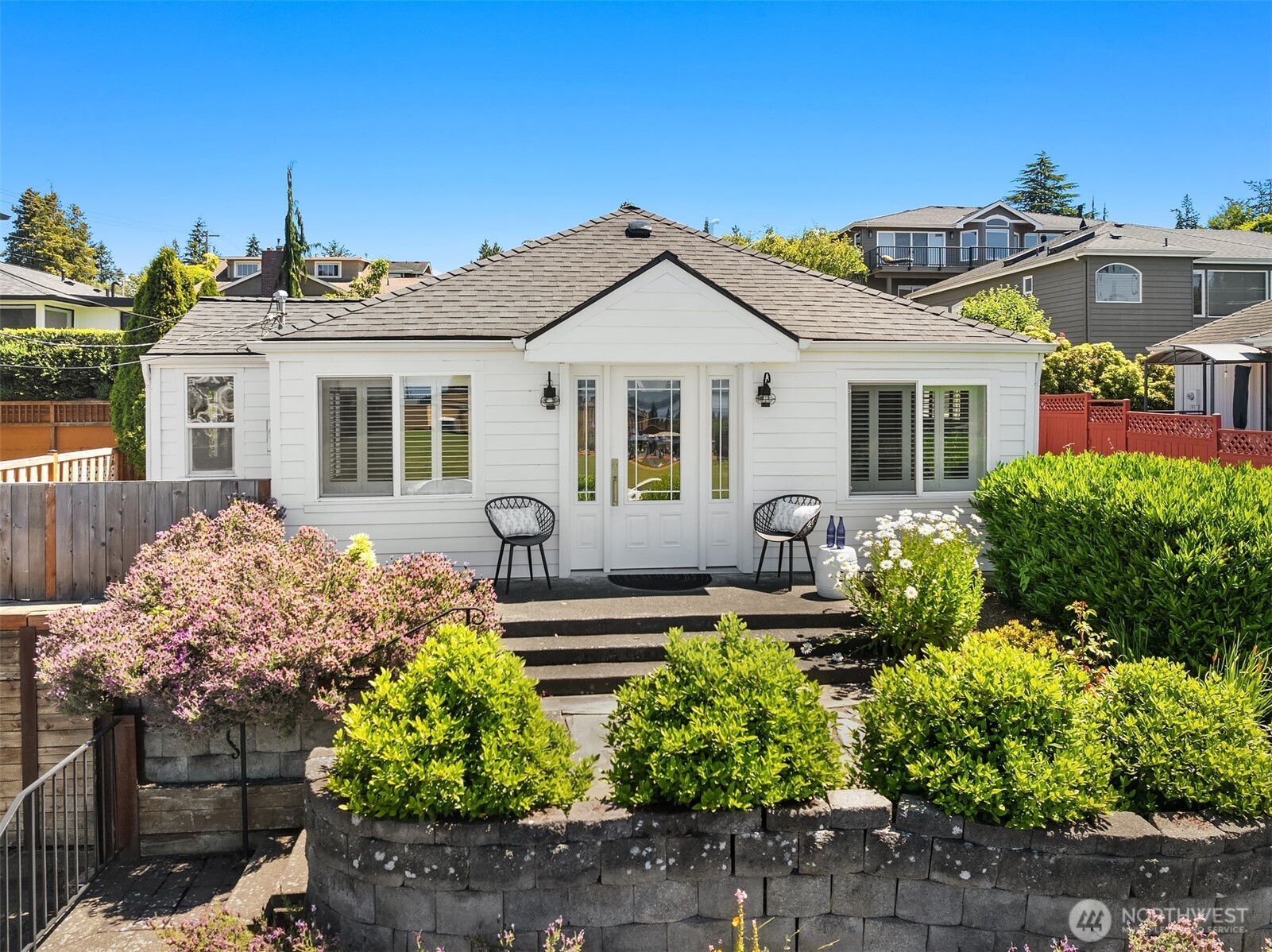 In the heart of the Edmonds Bowl, directly across from the location of beloved Edmonds Festivals & and community events, this charming 3-bedroom home offers an exceptional blend of location & lifestyle. With sweeping West-facing views of Puget Sound and the Olympic Mountains unwind each evening with sunset vistas from the comfort of home. Set above the street for added privacy, the thoughtfully designed front courtyard serves as an inviting outdoor living space perfect for entertaining, relaxing. Just moments from the Rec Center, library, downtown Edmonds, parks, dining, shopping, and the waterfront, you'll enjoy one of the area's most walkable and sought-after locations. The primary bedroom features vaulted ceilings and direct access to a peaceful private patio retreat. Additional highlights include abundant attic storage with pull-down access, updated landscaping with flagstone accents, newer exterior paint, and a newer washer and dryer. Whether you're looking for a primary residence, second home, or investment opportunity (would be an awesome AirBNB/VRBO), the unbeatable location and year-round appeal create excellent potential for short-term rental income. A rare opportunity to enjoy low-maintenance coastal living in one of Edmonds' most coveted neighborhoods, with the best of the Bowl right outside your door.