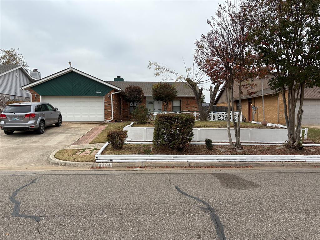 Beautiful house in East Ridge Addition, ready for move-in!  Three spacious bedrooms, two bathrooms and large 2 car garage.  Split mother-in-law plan.  Imposing brick fireplace in living room.  Gorgeous, polished woodwork throughout house.  Large sunroom with gleaming tile floor.  Ample built in display racks and shelves in living spaces to display your souvenirs and bric-a-brac.  New laminate floor in living room and two bedrooms.  Plenty of cabinets and countertop space in kitchen.  The lawn in front has a large fenced-in paved sitting area.  The backyard is partially paved, making for easier maintenance.  Newly painted exterior.  New roof in 2025.  Nicely landscaped front and back yards.  In close proximity to stores, banks and restaurants.  Easy access to Highway 9.  Reagan Elementary school and a large city park are in the neighborhood.  This might be the dream house that you always wanted, ready to move in and enjoy!  Check it out!