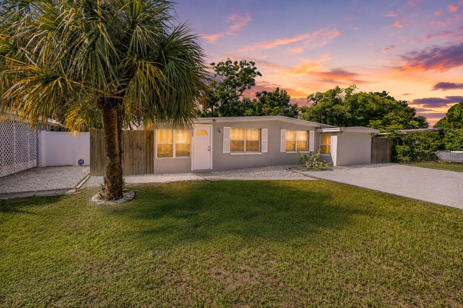Virtually Staged. Just 10 minutes to the beach, no flood zone, no HOA and no rental restrictions! This beautifully updated 3-bedroom, 2-bathroom home offers 1,294 square feet of bright, flexible living space with the major improvements already taken care of. Enjoy the confidence of a 2022 ROOF WITH HURRICANE CLIPS, 2022 ELECTRICAL PANEL, 2019 HVAC with UV light air purification and a 2019 WATER HEATER. Even the water systems have been upgraded with a whole house water treatment and softener system plus reverse osmosis purified drinking water, both added in 2025. Inside, the home feels bright, open and welcoming with abundant natural light and luxury vinyl flooring throughout. The renovated kitchen is at the heart of the home, featuring white shaker cabinetry, granite countertops, stainless steel appliances, a breakfast bar and a dedicated coffee bar with plenty of additional storage. The open concept living room overlooks the kitchen, while a fantastic bonus room provides the perfect space for a home office, playroom or sitting area. A desirable split bedroom floor plan provides added privacy. The spacious primary suite features its own separate exterior entrance, offering wonderful flexibility for guests, multigenerational living or an in-law suite. The ensuite bathroom features an impressively large walk-in shower, while the guest bathroom has been recently refreshed. Then there is the outdoor living space! A MASSIVE covered and screened patio spans the entire length of the home, creating the perfect setting for morning coffee, outdoor dining, entertaining friends or simply enjoying Florida living year-round. Beyond the patio, the fenced backyard is framed by mature trees, while an attached utility room with washer and dryer adds everyday convenience. There is also a storage shed and plenty of parking for residents and guests. Located in unincorporated Pinellas County with NO HOA, NO CDD, NO FLOOD ZONE and NO MINIMUM RENTAL PERIOD, this property offers incredible freedom and flexibility. Enjoy it as a full-time residence, Florida getaway or short-term rental opportunity, all just minutes from beautiful Gulf beaches, shopping, dining and everyday conveniences. Updated, versatile and ready to enjoy, this home delivers the Florida lifestyle without sacrificing the practical features that matter. Explore the video and immersive 3D tour, then schedule your private showing today!