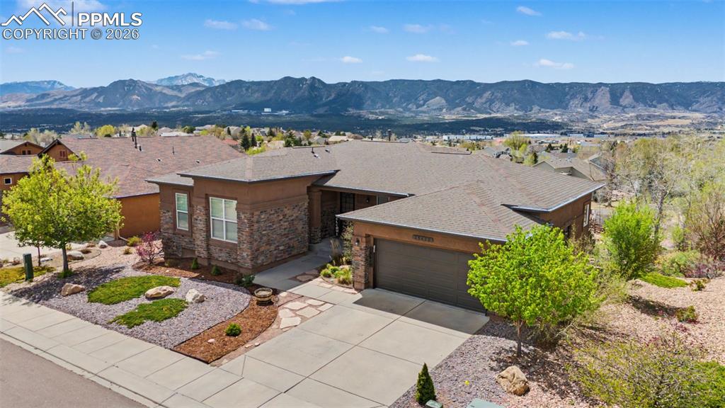 Sweeping views of the entire Front Range, iconic Pikes Peak, and the United States Air Force Academy—a rare blend of location, scenery, and space.Just minutes from I-25 and everyday amenities, this home features an open, light-filled floor plan—perfect for entertaining— a great kitchen with a walk-in pantry. The main-level primary suite includes a relaxing soaking tub. Situated with the rear of the house facing west, you can enjoy the stunning views inside from the primary suite and living room, or take in the beautiful sunsets outside on the spacious deck.The finished walkout basement offers flexible living with large bedrooms, a family room, wet bar, wine rack, gas fireplace, and covered patio—ideal for guests or multi-generational living. 3-car garage plus recent updates, including newer appliances, garage door, and water heater.
