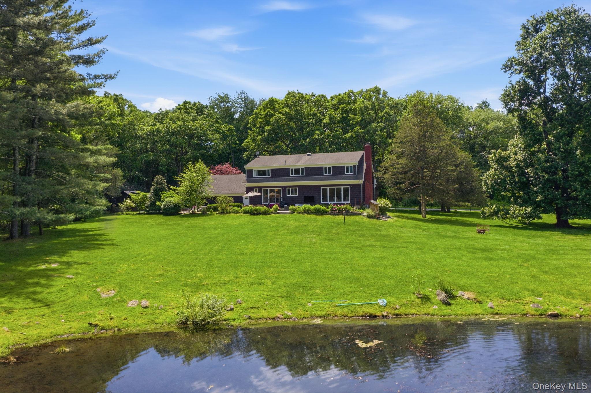 A chance to own in one of the most sought after neighborhoods in Pound Ridge. This expanded cape/colonial is a recreation lovers dream. Set on over two private acres, this home features a private pond, with flat manicured spaces made for indoor/outdoor living. Oversized windows enhance the view from every room and bathe the rooms in natural light; while the thoughtful floor plan provides generous living and entertaining spaces, hardwood floors and a seamless flow throughout. The finished basement adds to the flexible space in the home, adding secondary recreation space and endless possibilities. Recent improvements include a whole-house generator, updated primary bath, new HVAC system, and newly paved circular driveway. Outside, enjoy wide roads for walking or riding bikes and mature landscapes with quick access to: Bedford  Village, Scott's Corners, Mianus River Gorge, Zofnass Preserve, 684 and the Merritt Parkway within minutes. Come find your next chapter today!