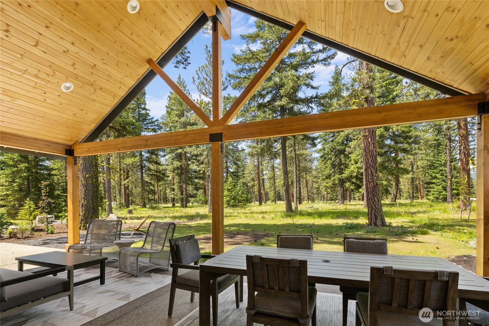 Expansive covered back patio adjacent to protected 3-acre meadow.