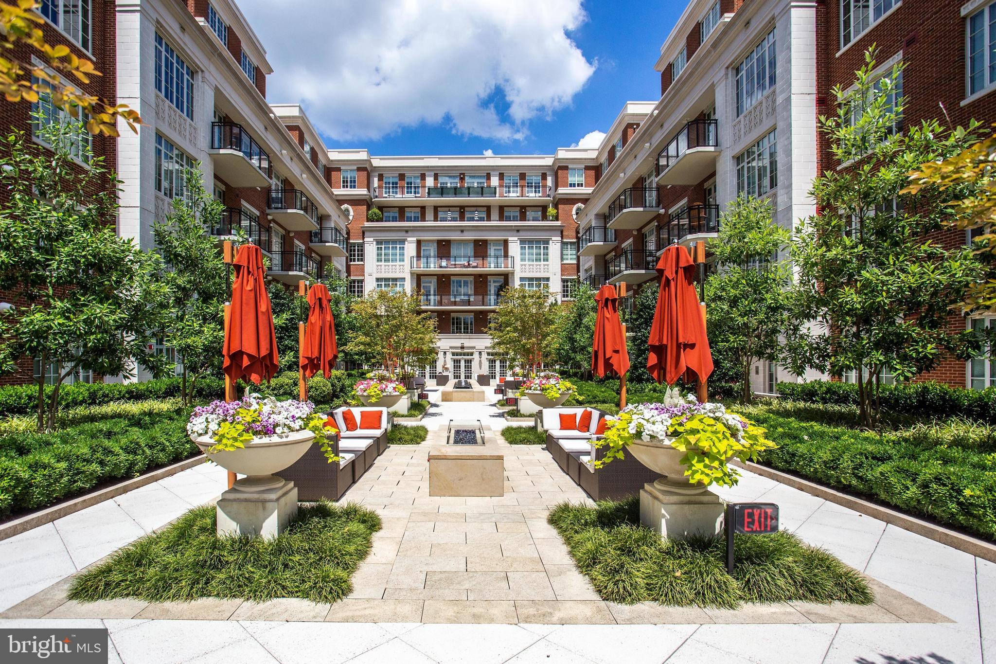 Welcome to The Signet, McLean’s premier luxury condo building, perfectly situated in the heart of the new-town streetscape. This exceptional location places you just blocks from downtown McLean’s vibrant retail and dining scene, minutes from Georgetown and DC, a little over a mile from the Silver Line Metro, and only three miles from Tysons Corner. This spacious third-floor unit features two generously sized bedrooms—each with its own balcony overlooking the serene Signet Park at Elm Street—along with two elegant bathrooms and walk-in closets. Beautiful hardwood floors extend throughout the open-concept layout, which showcases a stunning gourmet kitchen with a large island, top-of-the-line appliances, and seamless flow into the dining and living areas. Additional highlights include two reserved parking spaces in the secure garage (Spaces 297 & 298).The Signet features lots of amenities including a grand lobby entrance with full-serve concierge, beautifully landscaped courtyard with 4 lounge areas offering: tables, fire pit area with seating, Trellis-covered outdoor bar and grilling area with sink, fridge and dining tables. There is a clubroom, fitness center, sauna, steam room, massage room, fitness trail, pet spa & much more! The new home of McLean Project of the Arts will be ready by end of the year in the Rotonda with small coffee shop.